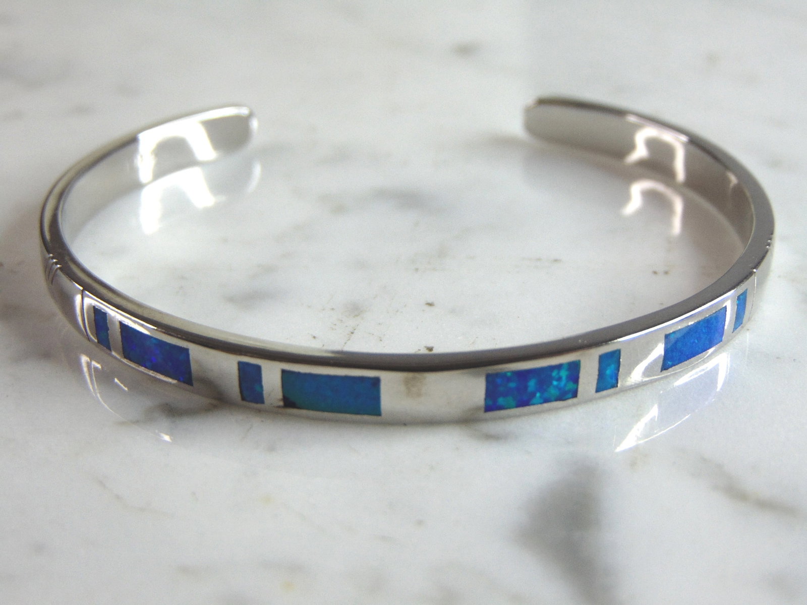 Womens Sterling Silver Modernist Opal Cuff Bracelet: A WOMENS STERLING SILVER MODERNIST OPAL CUFF BRACELET. THE BRACELET WEIGHS 14.0g AND IS ABOUT 1/4" WIDE. THE CIRCUMFERENCE WITH THE GAP IS 6". ANY QUESTIONS PLEASE DO NOT HESITATE TO ASK. BE SURE TO C