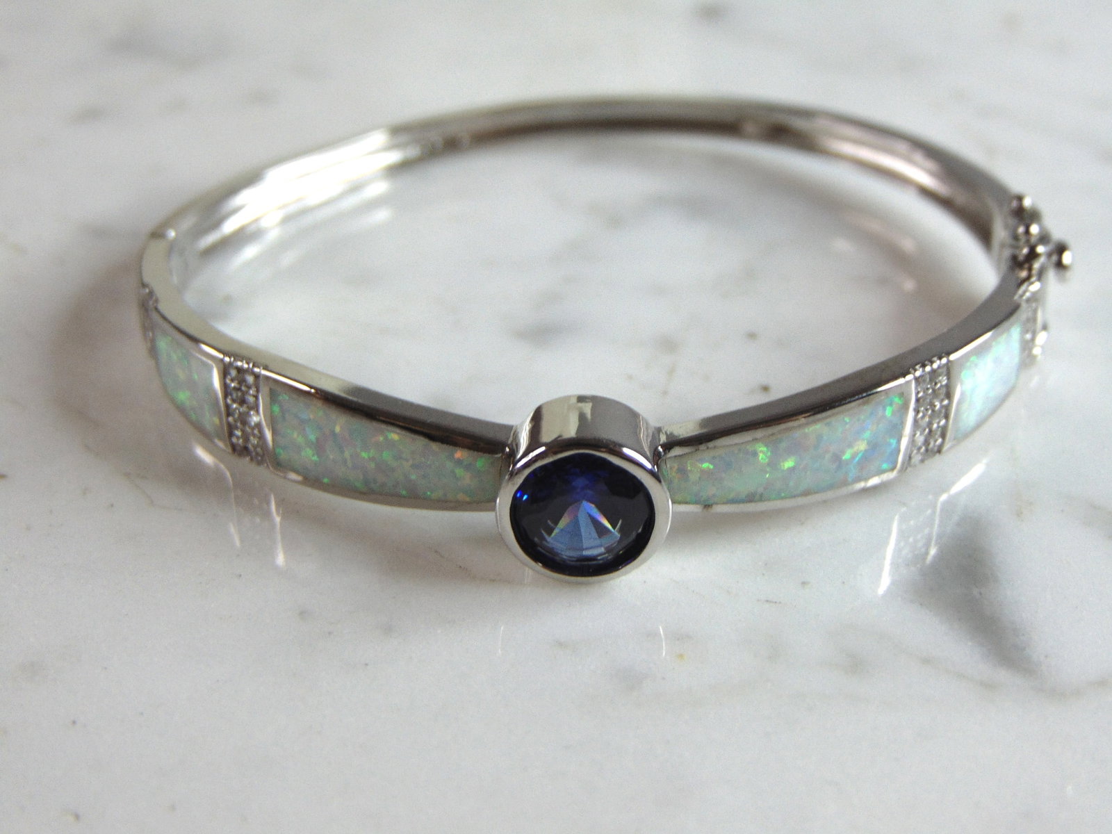 Womens Sterling Silver Modernist Opal Bangle Bracelet: A WOMENS STERLING SILVER MODERNIST OPAL BANGLE BRACELET. THE BRACELET WEIGHS 15.2g AND IS ABOUT 1/4" WIDE. THE CIRCUMFERENCE WITH THE GAP IS 6 1/2". ANY QUESTIONS PLEASE DO NOT HESITATE TO ASK. BE SUR