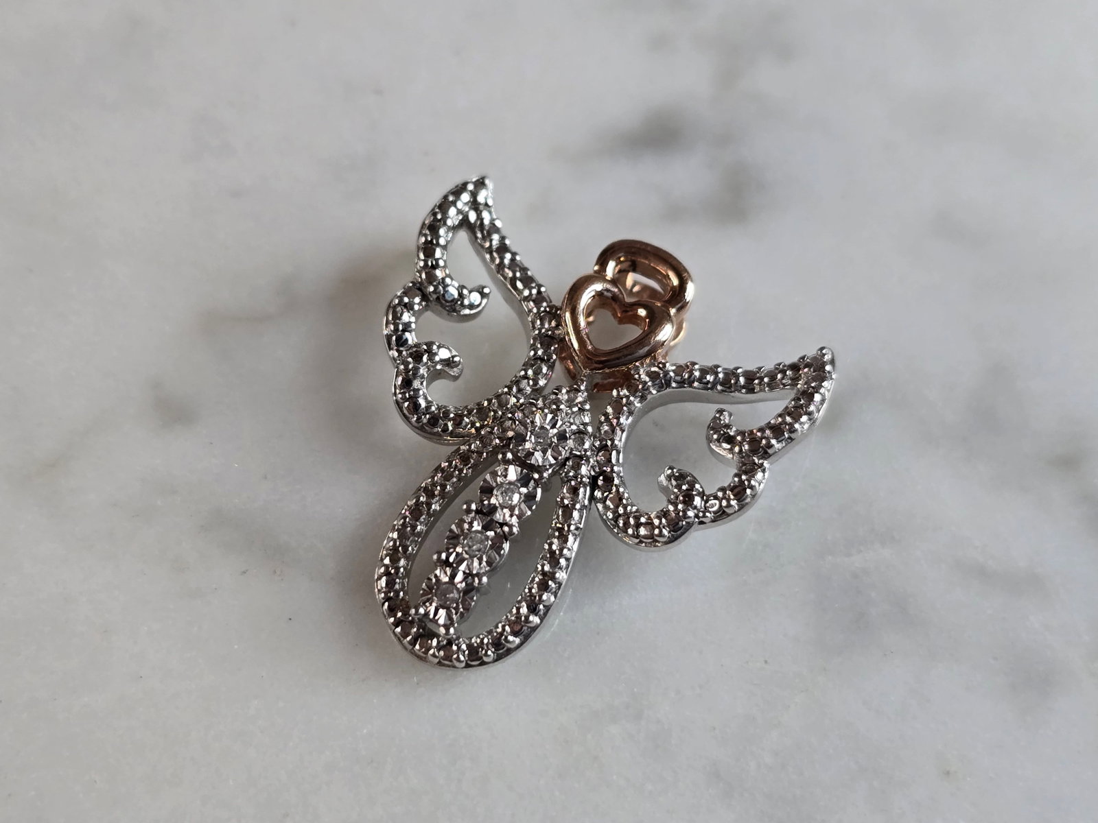 Womens Vintage Estate Sterling Silver Diamond Angel Pendant: A WOMENS VINTAGE ESTATE STERLING SILVER DIAMOND ANGEL PENDANT. THE PENDANT WEIGHS 2.2g, AND MEASURES 3/4" LONG BY 3/4" WIDE. THERE ARE ABOUT .04cts OF DIAMONDS IN THE PENDANT. PENDANT IS STAMPED "RL, 