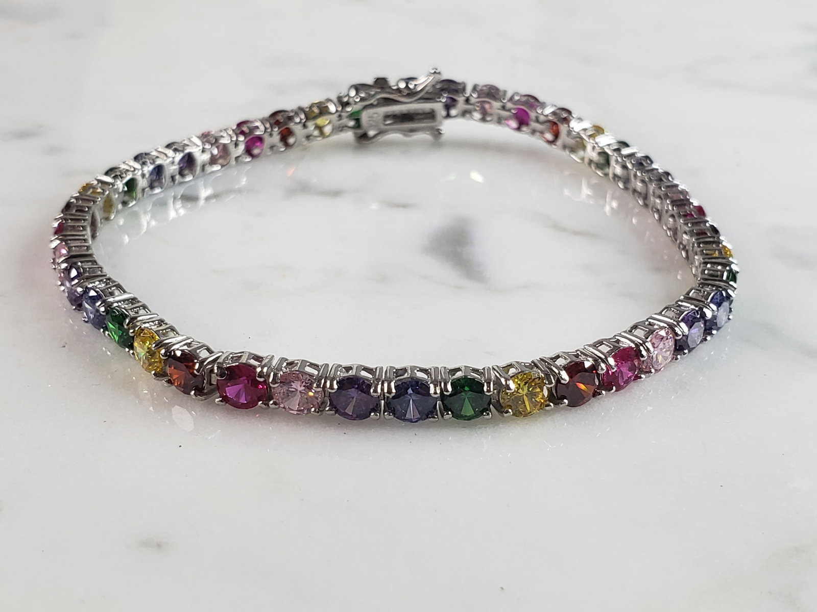 Womens Vintage Estate Sterling Silver Modernist Rainbow Bracelet: A WOMENS VINTAGE ESTATE STERLING SILVER MODERNIST RAINBOW BRACELET. NOT SURE IF STONES ARE NATURAL OR MAN MADE. BRACELET MEASURES 7 5/8" LONG BY ABOUT 1/8" WIDE AND WEIGHS 11.0g. THIS WOULD MAKE A LOV