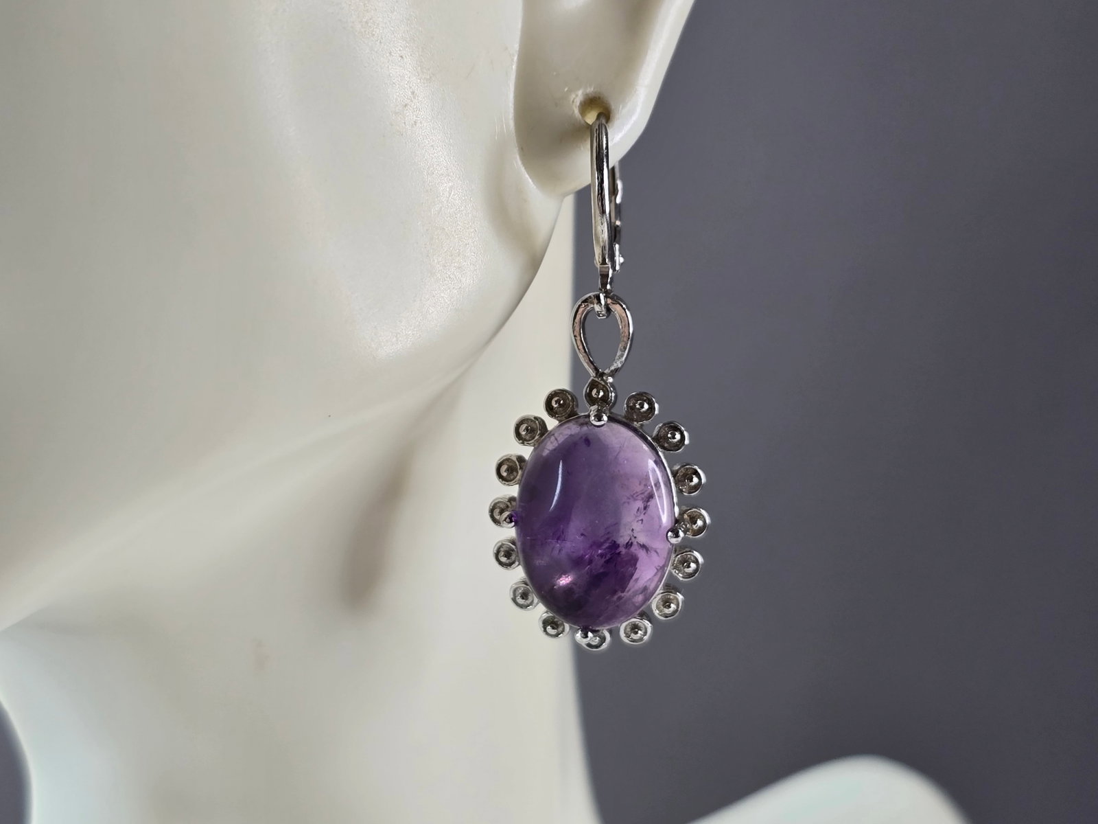 Womens Estate Sterling Silver Amethyst Earrings: A PAIR OF WOMENS ESTATE STERLING SILVER AMETHYST COLORED EARRINGS. EARRINGS WEIGH 9.2g, AND MEASURE 1 1/2" LONG BY 5/8" WIDE. NOT SURE IF STONES ARE NATURAL OR MANMADE. ANY QUESTIONS, PLEASE DO NOT HE