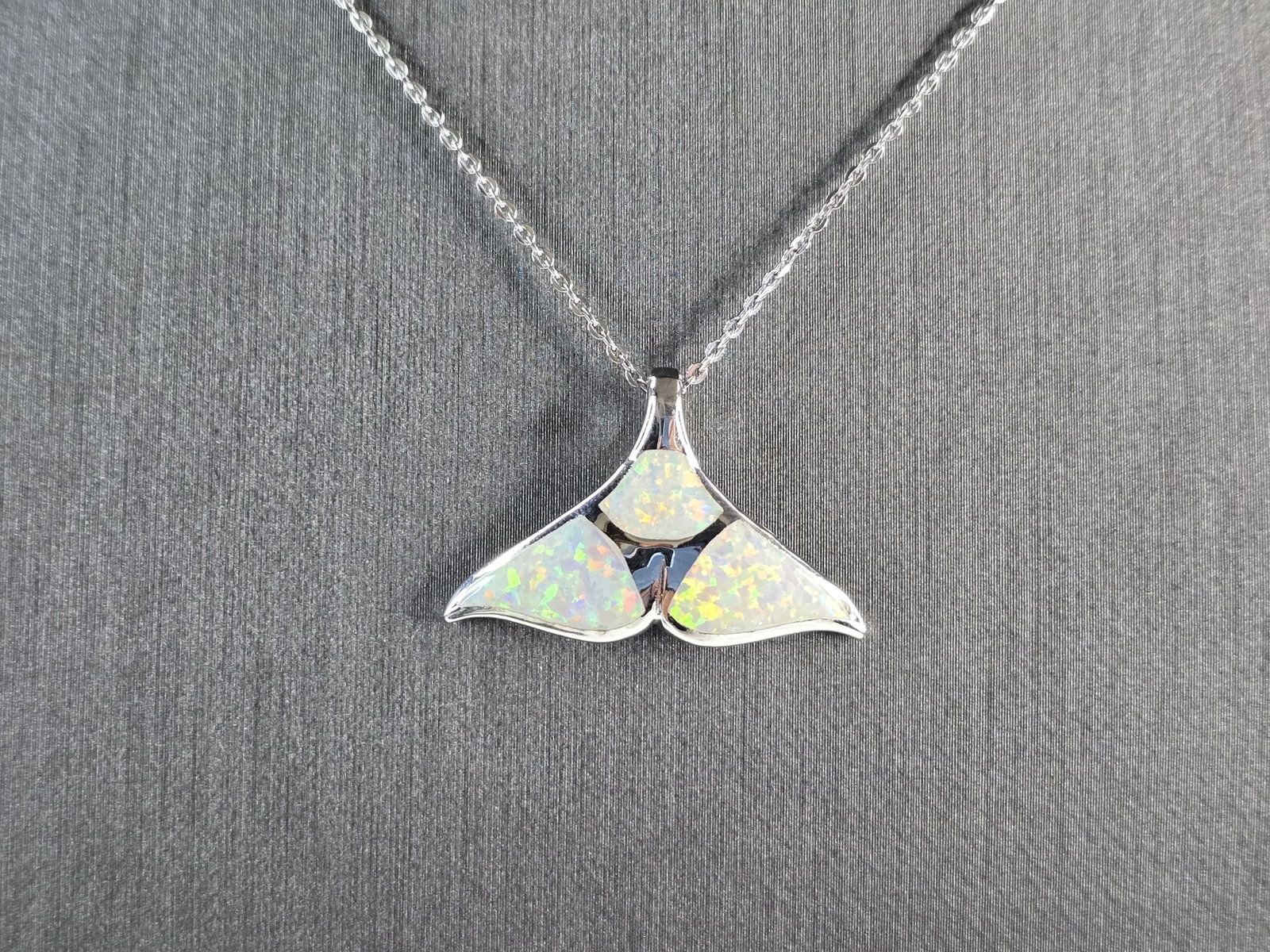 Womens Sterling Silver Opal Modernist Whale Tail Pendant Necklace: A WOMENS STERLING SILVER OPAL MODERNIST WHALE TAIL PENDANT. THE PENDANT WITH NECKLACE WEIGHS 5.4g. PENDANT MEASURES 1" LONG BY 5/8" WIDE, AND THE NECKLACE MEASURES 18" LONG, ADJUSTABLE TO 16". NOT SUR