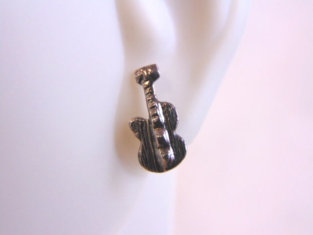 Womens Sterling Silver Rock N Roll Guitar Earrings: FOR SALE IS THIS PAIR OF STERLING SILVER ROCK N ROLL GUITAR EARRINGS. THE EARRINGS WEIGH 1.0g. AND MEASURE 1/2" LONG BY 1/4" WIDE. THIS MAKES A LOVELY GIFT FOR THAT SOMEONE SPECIAL. IF ANY QUESTIONS, 