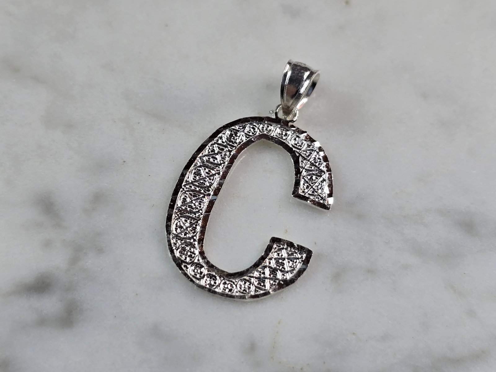Womens Sterling Silver Initial Letter " C " Pendant: A WOMENS STERLING SILVER INITIAL LETTER "C" PENDANT. PENDANT WEIGHS 1.1g AND MEASURES 1 1/8" LONG BY 3/4" WIDE. MAKES A GREAT GIFT FOR THAT SOMEONE SPECIAL. ANY QUESTIONS, PLEASE ASK. BE SURE TO CHECK