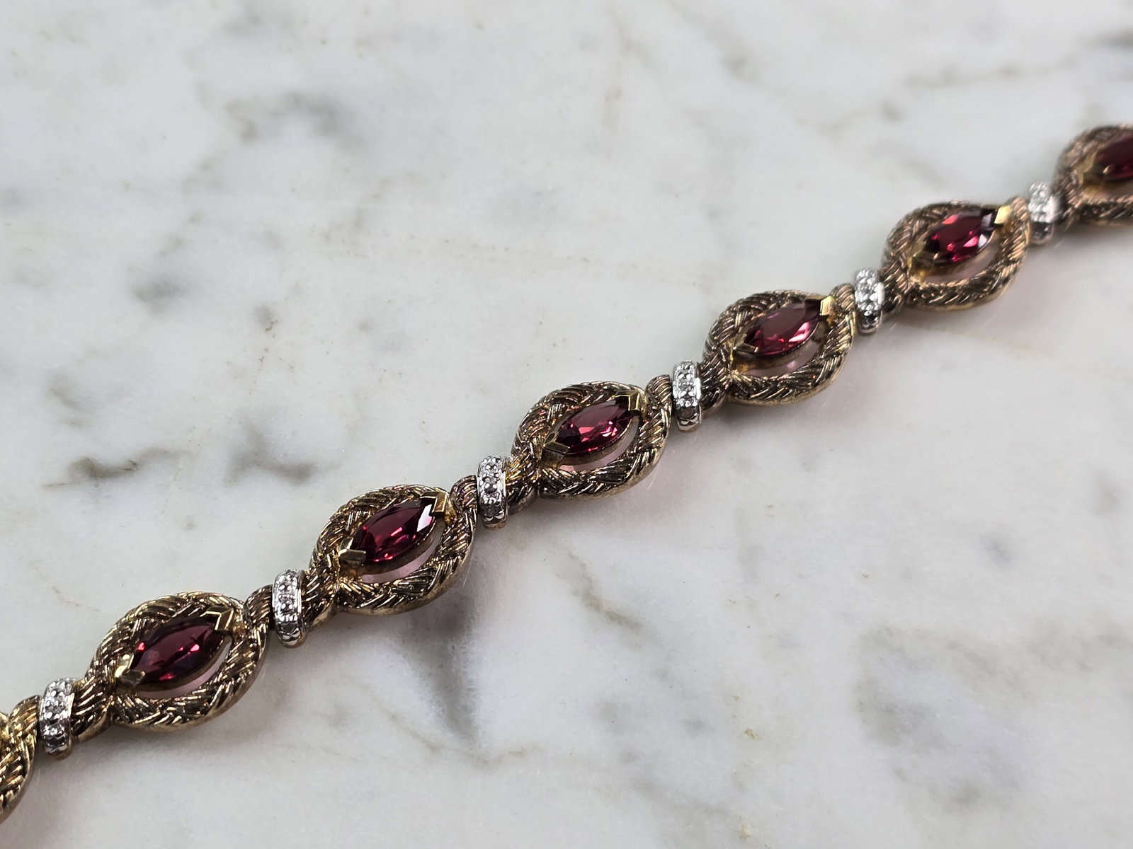 Womens Vintage Estate Sterling Silver Gold Tone Bracelet: A WOMENS VINTAGE ESTATE STERLING SILVER GOLD TONE BRACELET WITH RUBY COLORED STONES. BRACELET IS ABOUT 7 1/2" LONG BY 3/8" WIDE AND WEIGHS 17.9g. NOT SURE IF STONES ARE NATURAL OR MAN MADE. WOULD MAKE