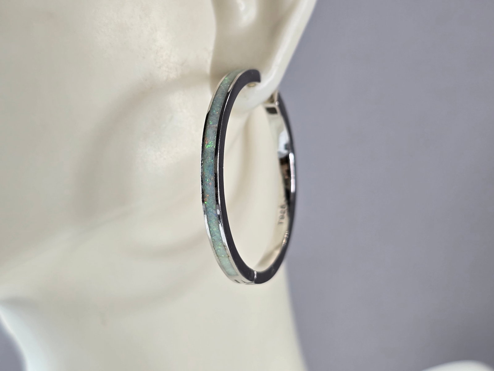 Womens Sterling Silver Modernist Opal Hoop Earrings: A PAIR OF WOMENS STERLING SILVER OPAL COLORED EARRINGS THAT WEIGH 9.1g, AND MEASURES 1 1/4" BY 1/8" WIDE. NOT SURE IF STONES ARE NATURAL OR MAN MADE. ANY QUESTIONS, PLEASE DO NOT HESITATE TO ASK. BE S