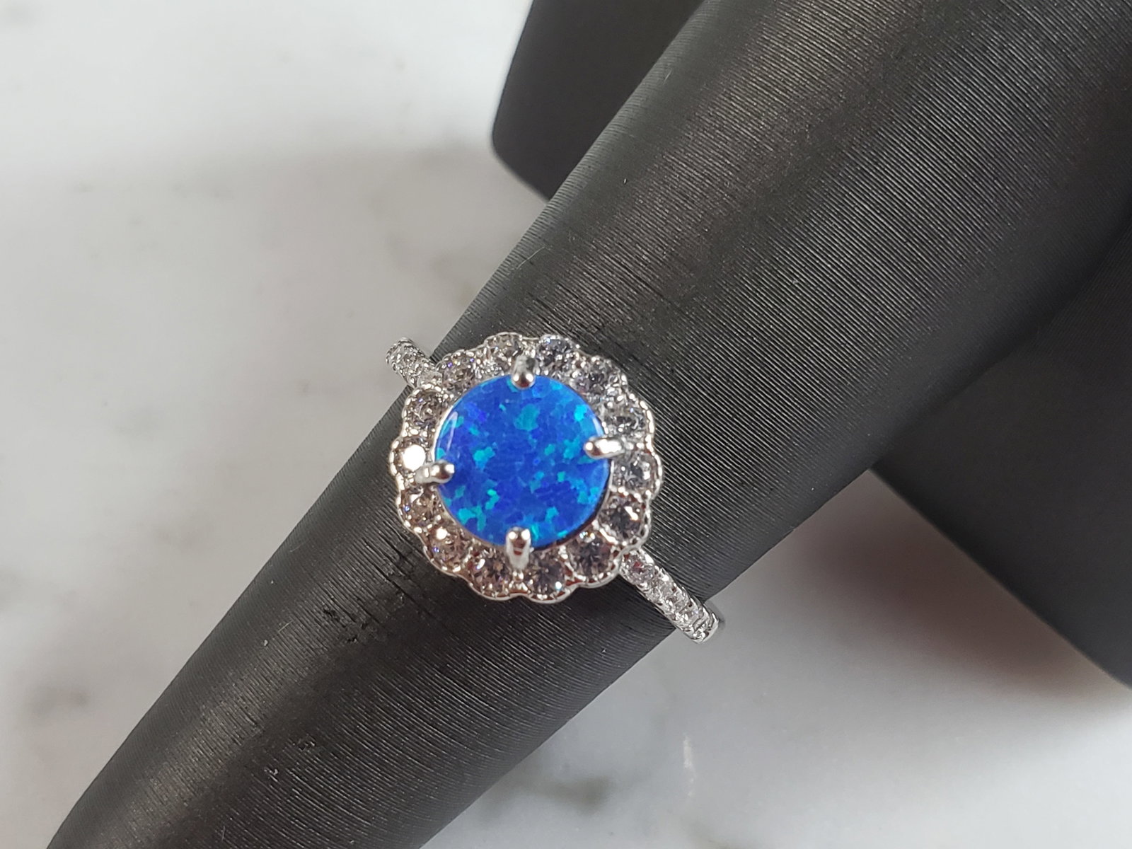 Womens Estate Sterling Silver Modernist Blue Opal Ring: A WOMENS ESTATE STERLING SILVER MODERNIST OPAL COLORED RING. THE RING IS A SIZE 6.5 AND WEIGHS 3.2g. NOT SURE IF STONE IS NATURAL OR MAN MADE. THE RING MAKES A BEAUTIFUL GIFT FOR THAT SOMEONE SPECIAL.
