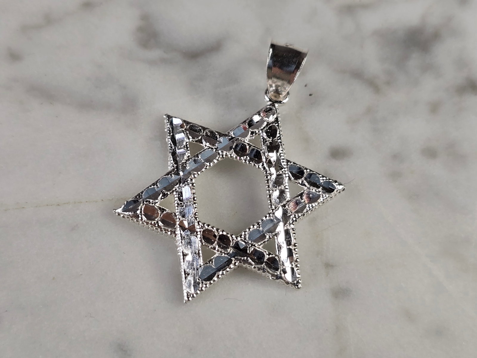 Sterling Silver Jewish Judaica Star of David Pendant: A STERLING SILVER STAR OF DAVID PENDANT. THE PENDANT WEIGHS 2.4g AND MEASURES 1 1/2" LONG BY 1" WIDE. STAMPED ON THE INSIDE OF THE BALE "925". MAKES A GREAT GIFT FOR THAT SOMEONE SPECIAL. ANY QUESTION