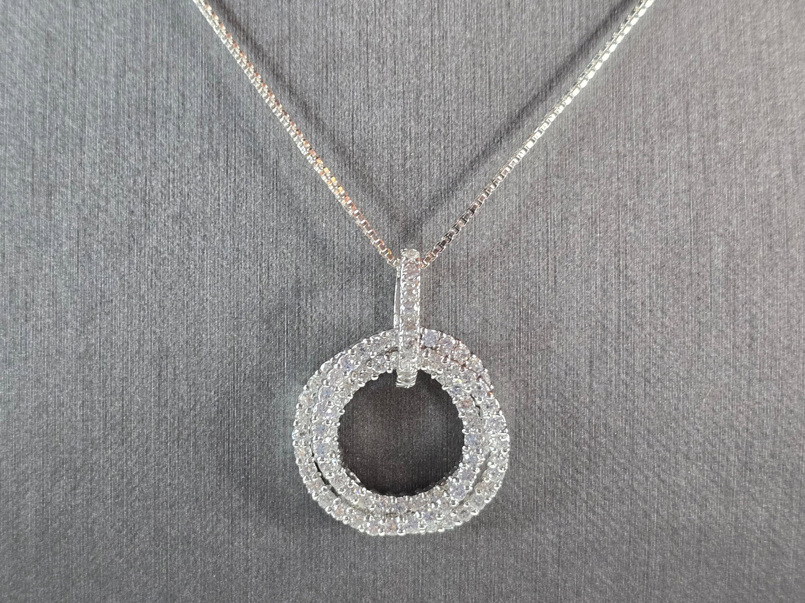 Womens Vintage Estate Sterling Silver CZ Eternity Pendant W/ Necklace: A WOMENS VINTAGE ESTATE STERLING SILVER CZ STONES ETERNITY PENDANT WITH NECKLACE. THE PENDANT MEASURES 1 1/4" BY 1". NECKLACE MEASURES 18 3/4". TOGETHER THEY WEIGH 9.1g. WOULD MAKE A GREAT GIFT FOR TH