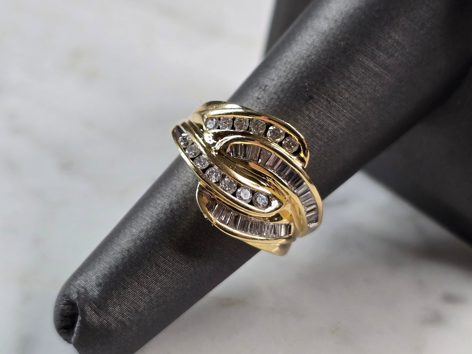 Womens Vintage Estate 14K Yellow Gold Modernist Diamond Ring: A WOMENS VINTAGE ESTATE 14K YELLOW GOLD MODERNIST DIAMOND RING. RING HAS ABOUT .52cts OF DIAMONDS. THE TOTAL WEIGHT IS 5.7g, AND IS A SIZE 6.25. THE WIDTH OF THE RING IS 1/2". ANY QUESTIONS PLEASE DON