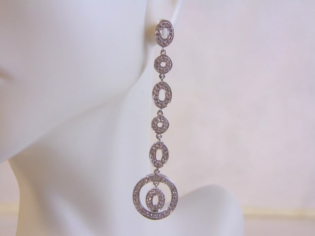 Vintage Estate Sterling Silver Earrings w/ CZ Stones: A PAIR OF WOMENS STERLING SILVER DANGLE EARRINGS WITH CZ STONES THAT WEIGH 5.0g AND MEASURES 2 1/4" LONG BY 1/2" WIDE. ANY OTHER QUESTIONS, PLEASE DO NOT HESITATE TO ASK. BE SURE TO CHECK OUT SOME OF 