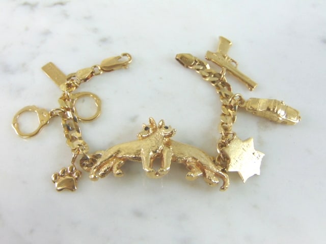 Womens Vintage 14k Gold Police Dog Charm Bracelet: FOR SALE IS A WOMENS VINTAGE ESTATE 14k GOLD POLICE DOG GERMAN SHEPARD CHARM BRACELET. THE BRACELET WEIGHS 31.6g, AND MEASURES 6 1/4" LONG. THE EYES OF THE DOG APPEAR TO BE BLUE SAPPHIRES. THE ONE CHA