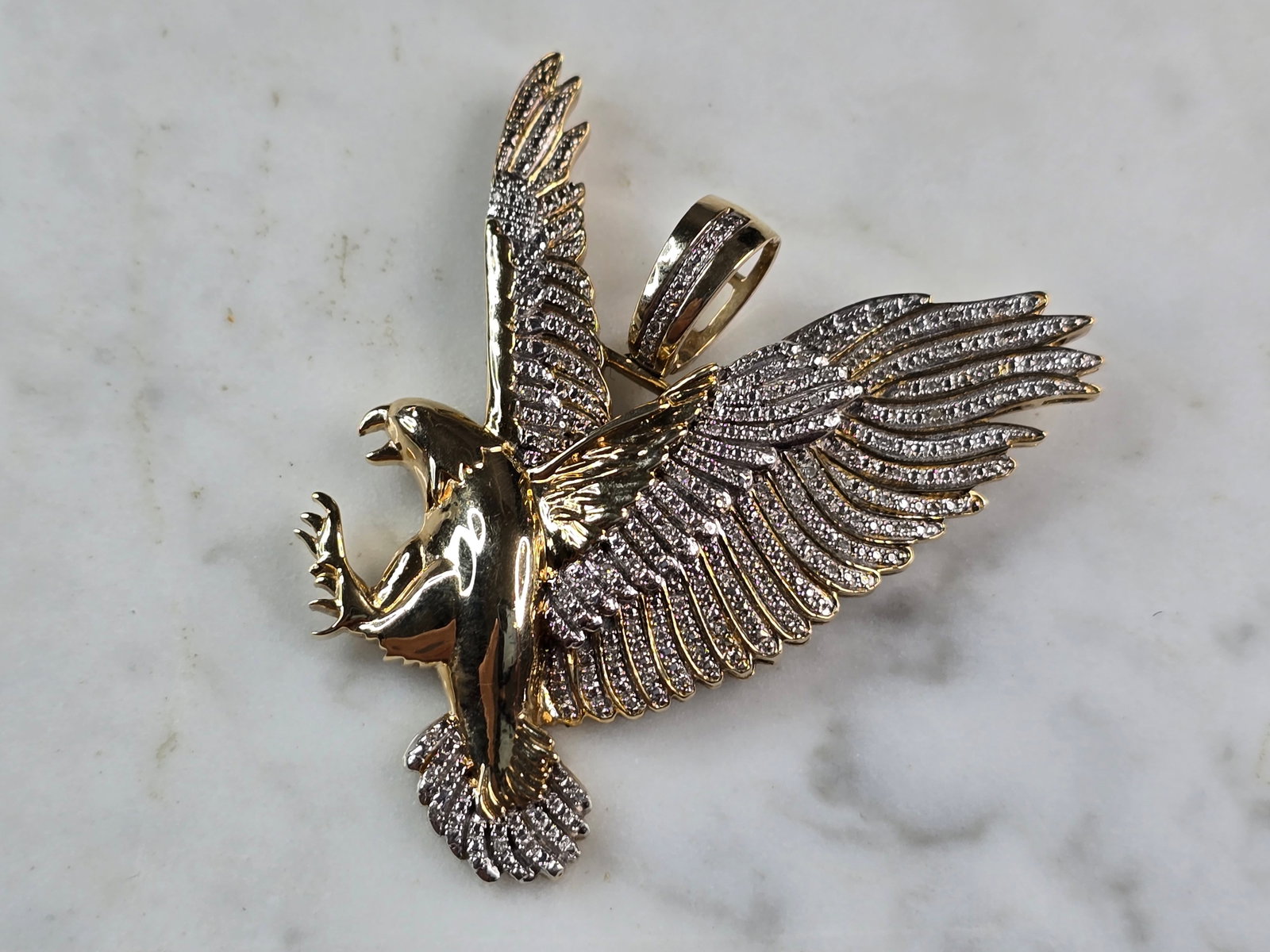 Mens Vintage Estate 10K Yellow Gold Diamond Eagle Pendant: A MENS VINTAGE ESTATE 10K YELLOW DIAMOND EAGLE PENDANT. THE PENDANT WEIGHS 15.9g AND MEASURES 2" BY 1 3/4". THERE ARE ABOUT 50 TINY DIAMONDS IN THIS PENDANT. MAKES A GREAT GIFT FOR THAT SOMEONE SPECIA