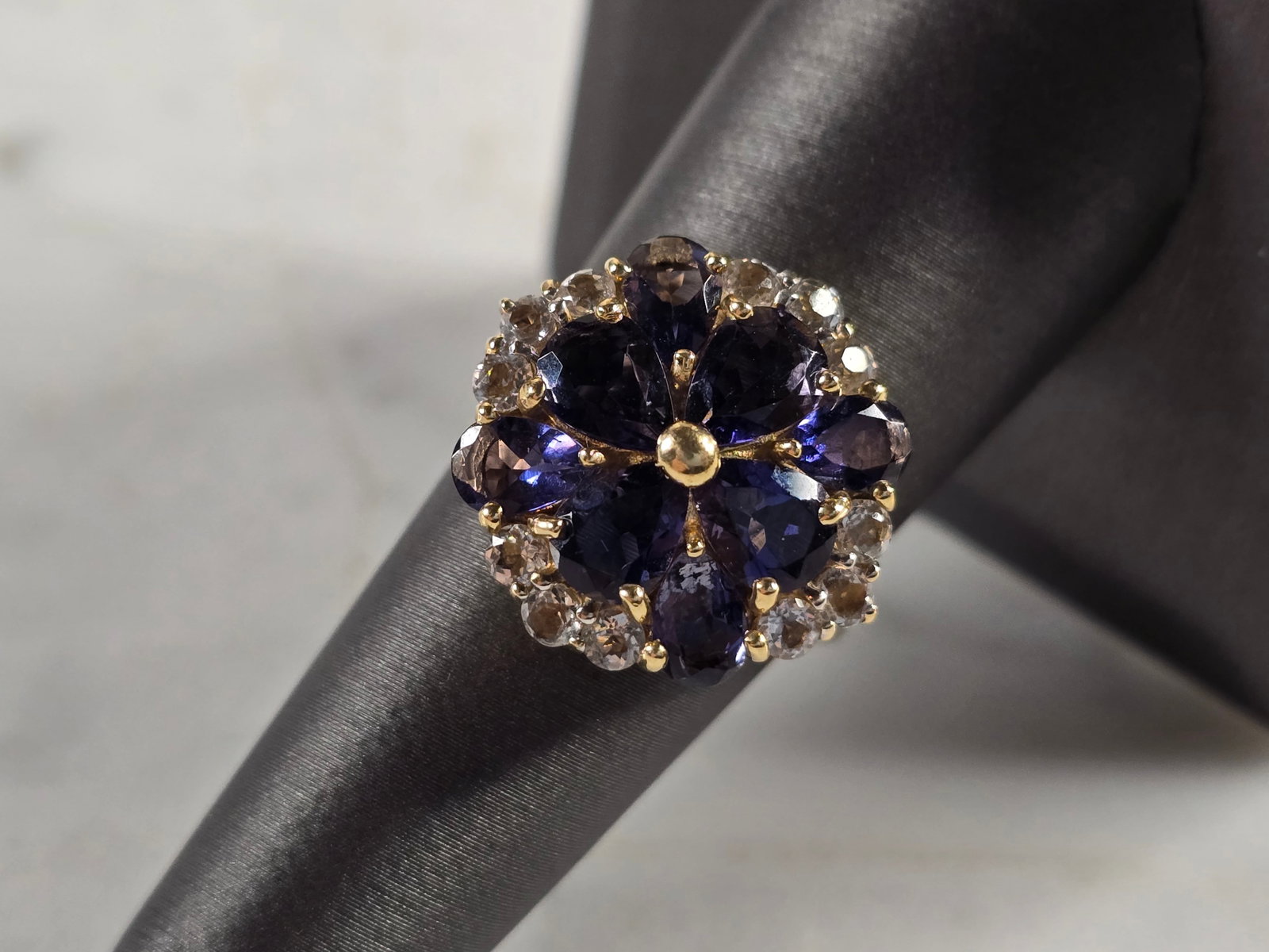 Womens Vintage Estate 14K Gold Tanzanite & CZ Floral Ring: A WOMENS VINTAGE ESTATE 14K YELLOW GOLD FLORAL RING WITH TANZANITE & CZ STONES. THE TOTAL WEIGHT IS 6.0g, AND IS A SIZE 8.0. THE WIDTH OF THE RING IS 3/4". NOT SURE IF STONES ARE NATURAL OR MAN MADE. 