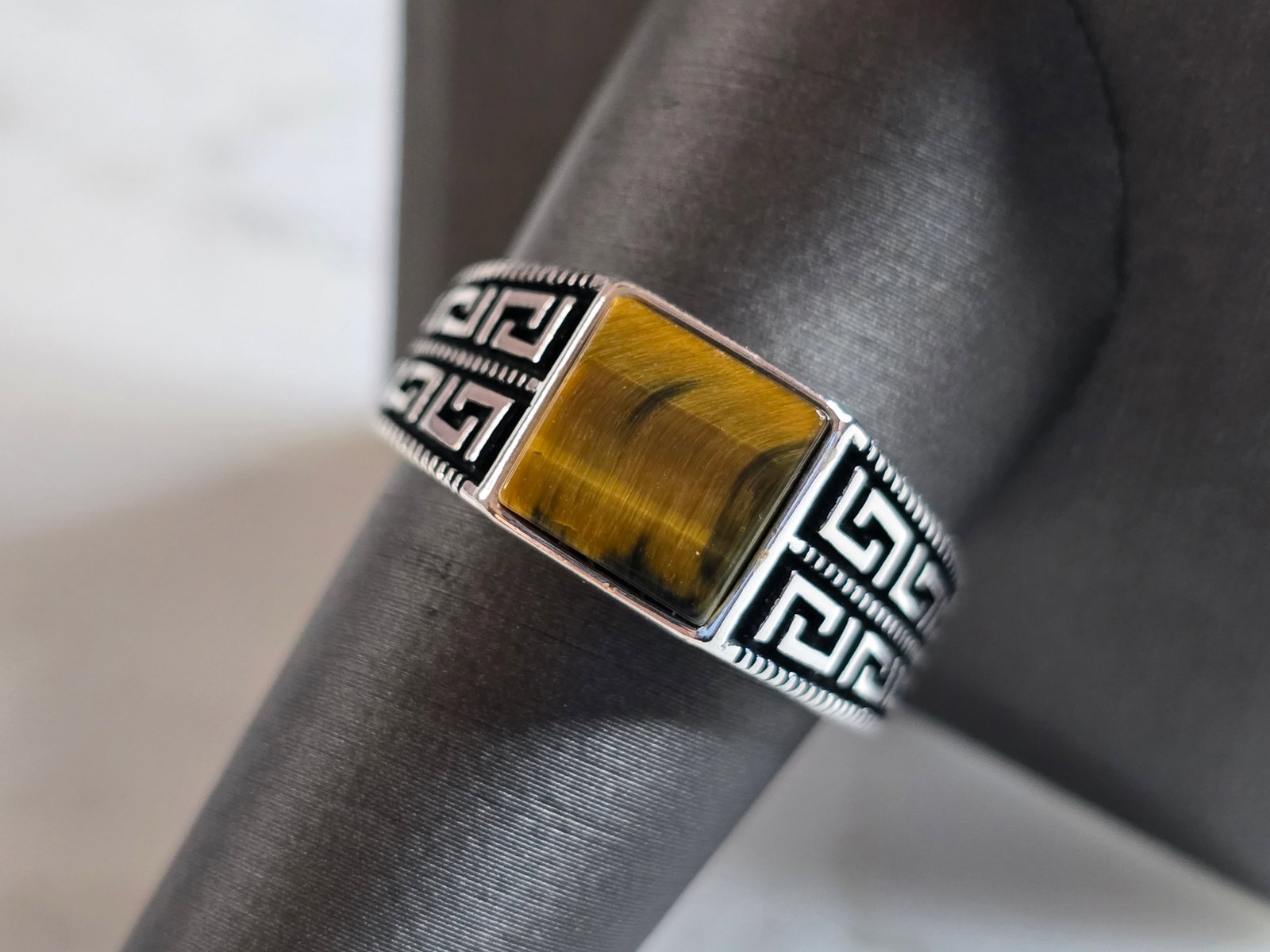 Mens Estate Sterling Silver Modernist Tigers Eye Ring: A MENS ESTATE STERLING SILVER TIGERS EYE RING. THE RING WEIGHS 6.3g AND IS A SIZE 10.0. THE FACE MEASURES 3/8" WIDE. ANY QUESTIONS PLEASE DO NOT HESITATE TO ASK. BE SURE TO CHECK OUT SOME OF OUR OTHER