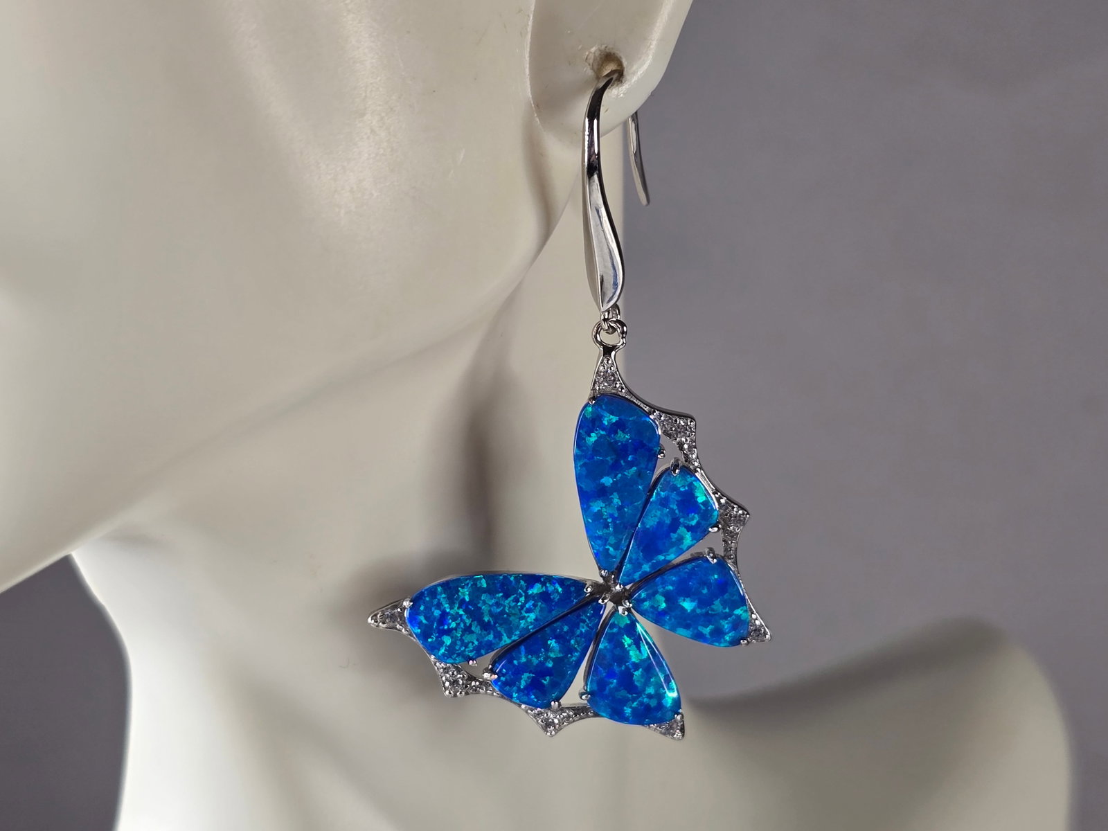 Womens Estate Sterling Silver Blue Opal Butterfly Earrings: A PAIR OF WOMENS STERLING SILVER BLUE OPAL COLORED BUTTERFLY EARRINGS THAT WEIGH 7.7g AND MEASURES 2" LONG BY 1 1/8" WIDE. NOT SURE IF STONES ARE REAL OR MAN MADE. ANY QUESTIONS, PLEASE DO NOT HESITAT