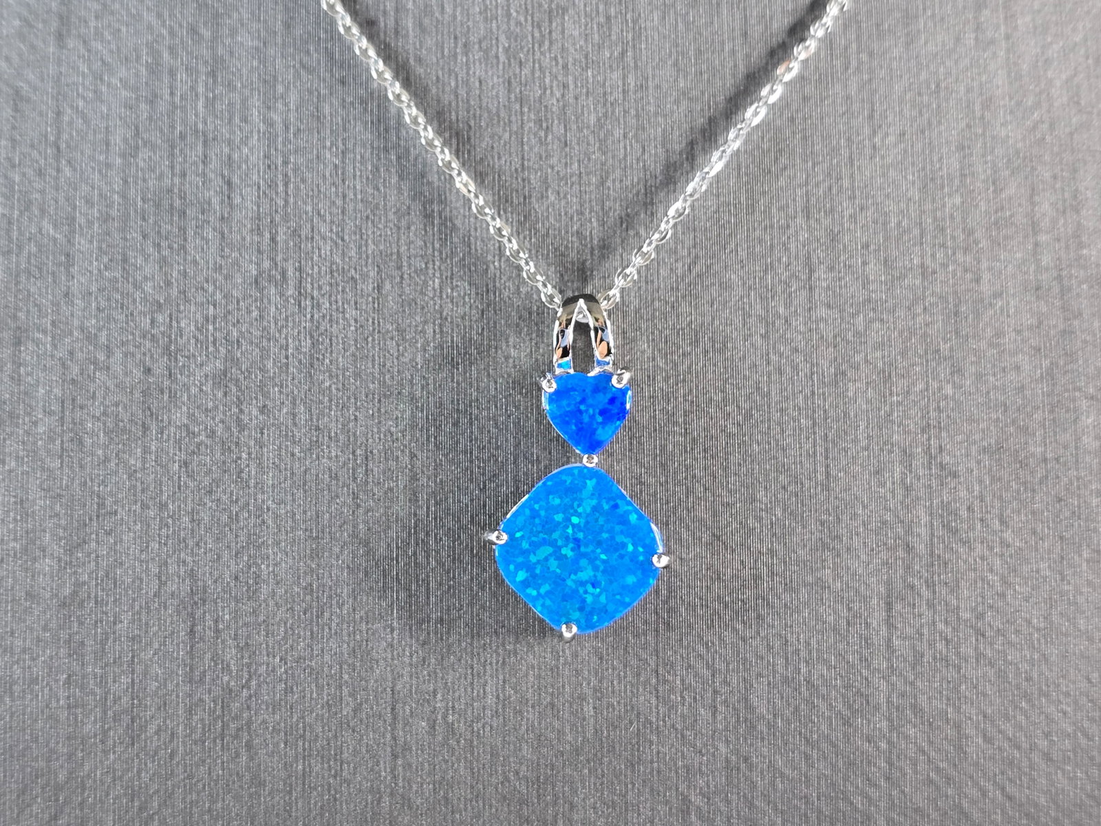 Womens Sterling Silver Blue Opal Modernist Heart Pendant Necklace: A WOMENS STERLING SILVER BLUE OPAL MODERNIST HEART PENDANT. THE PENDANT WITH NECKLACE WEIGHS 3.0g. THE PENDANT MEASURES 7/8" LONG BY 1/2" WIDE. THE NECKLACE MEASURES 18" LONG AND IS ADJUSTABLE TO 16" 