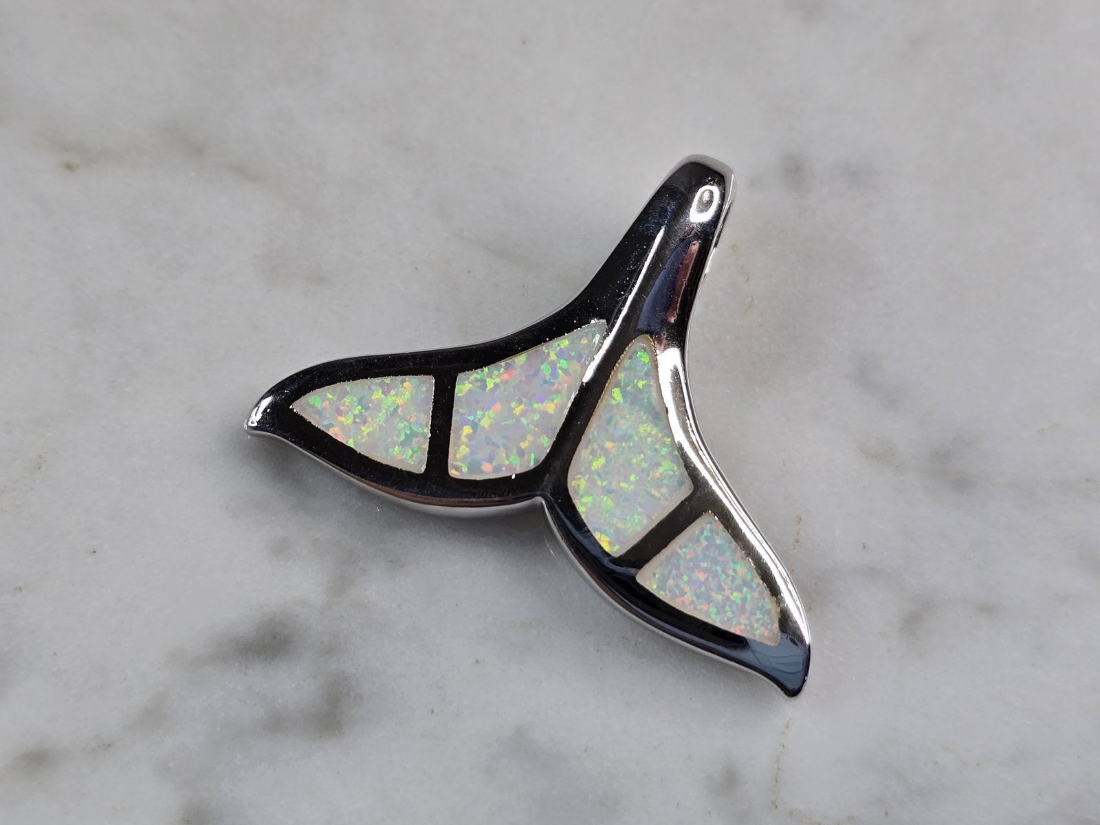 Womens Sterling Silver Opal Modernist Whale Tail Pendant: A WOMENS STERLING SILVER OPAL MODERNIST WHALE TAIL PENDANT. NOT SURE IF STONES ARE NATURAL OR MAN MADE. THE PENDANT WEIGHS 6.1g AND MEASURES 1 1/4" LONG BY 7/8" WIDE. MAKES A GREAT GIFT FOR THAT SOMEO