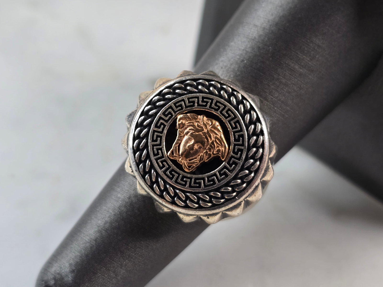 Mens Sterling Silver Two Tone Greek Key Medusa Ring: A MENS STERLING SILVER TWO TONE GREEK KEY MEDUSA RING. THE TOTAL WEIGHT IS 11.1g, AND IS A SIZE 7.25. THE WIDTH OF THE RING IS 3/4". RING WOULD MAKE A GREAT GIFT FOR SOMEONE SPECIAL. ANY QUESTIONS PLE