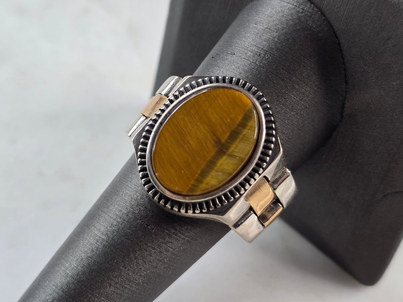 Mens Sterling Silver Tigers Eye Watch Band Ring: A MENS STERLING SILVER TIGERS EYE WATCH BAND RING. THE RING IS A SIZE 9.25, AND WEIGHS 13.9g. FACE MEASURES ABOUT 3/4" WIDE. THE RING MAKES A BEAUTIFUL, IMPRESSIVE GIFT FOR THAT SOMEONE SPECIAL. ANY Q