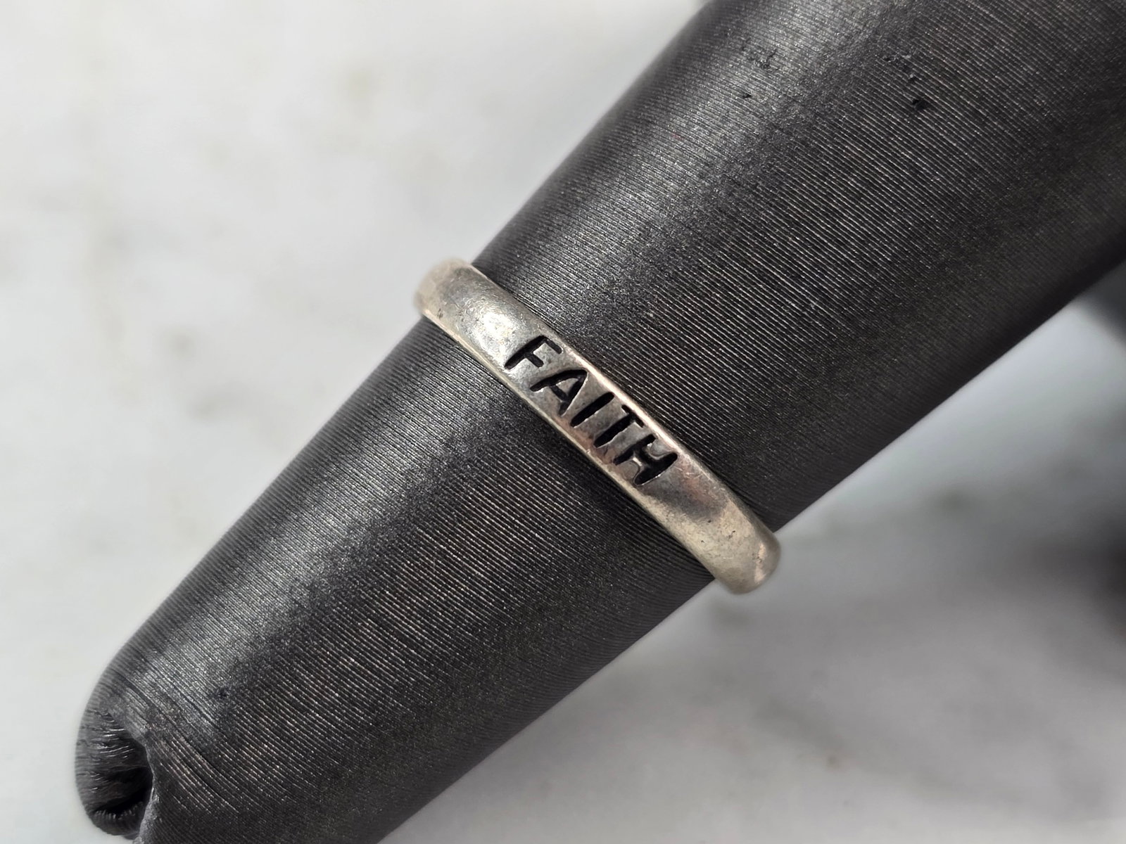 Womens Vintage Estate Sterling Silver Faith Ring: A WOMENS VINTAGE ESTATE STERLING SILVER "FAITH" RING. THE RING SIZE IS A 5.0, AND WEIGHS 1.2g. THE WIDTH OF THE RING IS 1/8". THIS WOULD MAKE A NICE GIFT FOR THAT SOMEONE SPECIAL. ANY OTHER QUESTIONS 