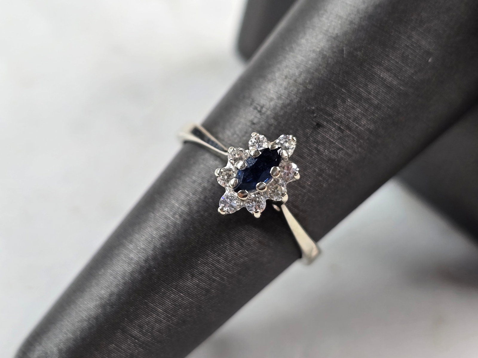Womens Vintage Estate 14K White Gold Sapphire Diamond Ring: A WOMENS VINTAGE ESTATE 14K WHITE GOLD RING WITH A BLUE SAPPHIRE STONE, ACCENTED BY 8 SMALL DIAMONDS. THE RING WEIGHS 2.4g, AND IS A SIZE 6.5. THE LENGTH OF THE RING IS 3/8". SAPPHIRE IS ABOUT 0.20cts