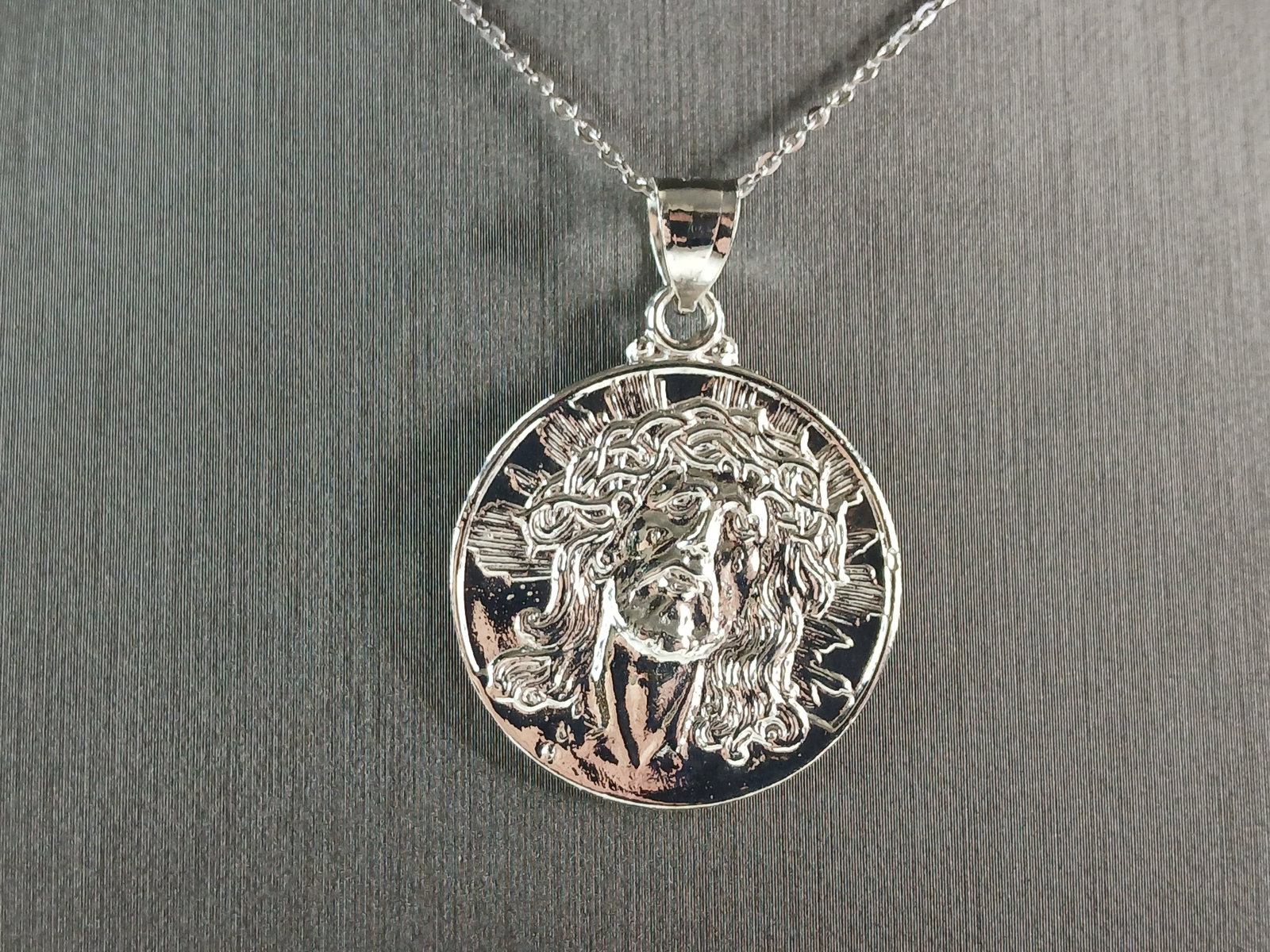 Womens Sterling Silver Jesus Pendant Necklace: A WOMENS STERLING SILVER RELIGIOUS JESUS PENDANT WITH NECKLACE . THE TOTAL WEIGHT IS 9.6g. THE PENDANT MEASURES 1 1/2" LONG BY 1 1/4" WIDE. THE NECKLACE MEASURES 18" LONG AND IS ADJUSTABLE TO 16" LONG