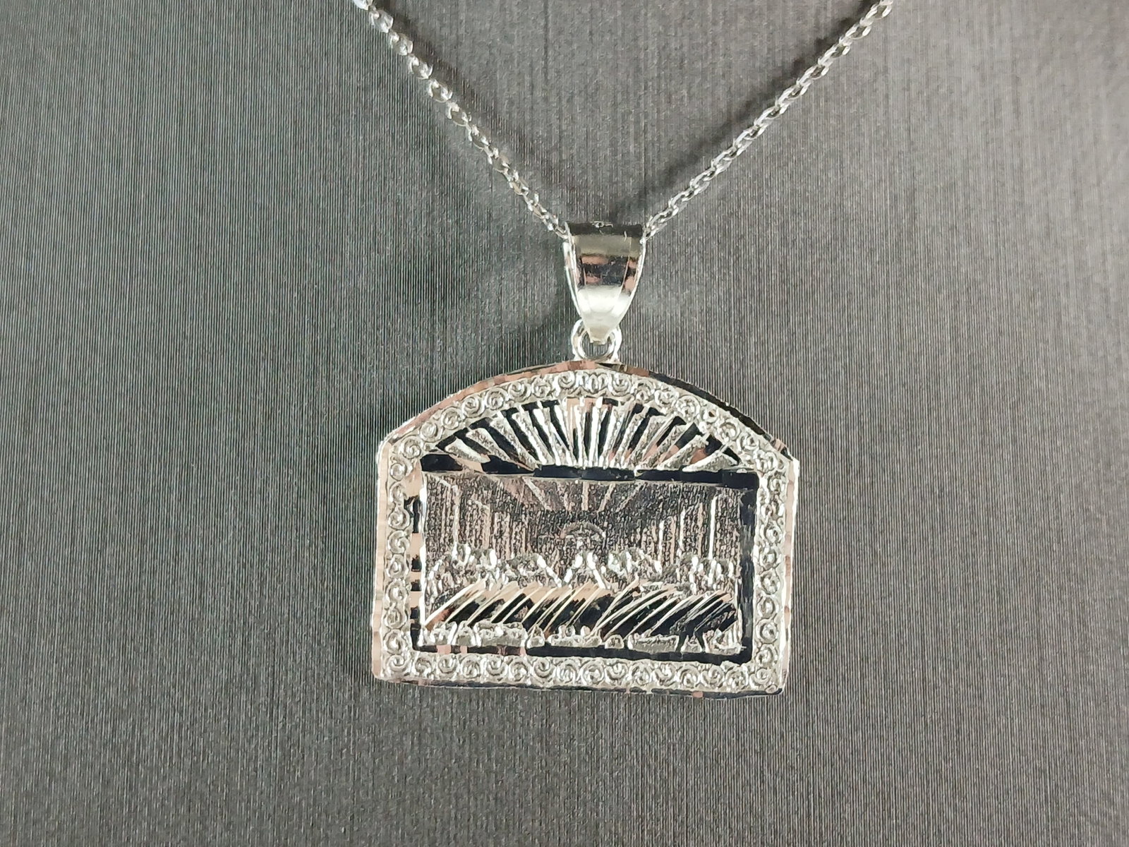 Sterling Silver Religious Last Supper Pendant Necklace: A STERLING SILVER RELIGIOUS LAST SUPPER PENDANT WITH NECKLACE. PENDANT WITH NECKLACE WEIGHS 6.4g. THE PENDANT MEASURES 1 1/4" LONG BY 1 1/8" WIDE. THE NECKLACE MEASURES 18" LONG AND IS ADJUSTABLE TO 1