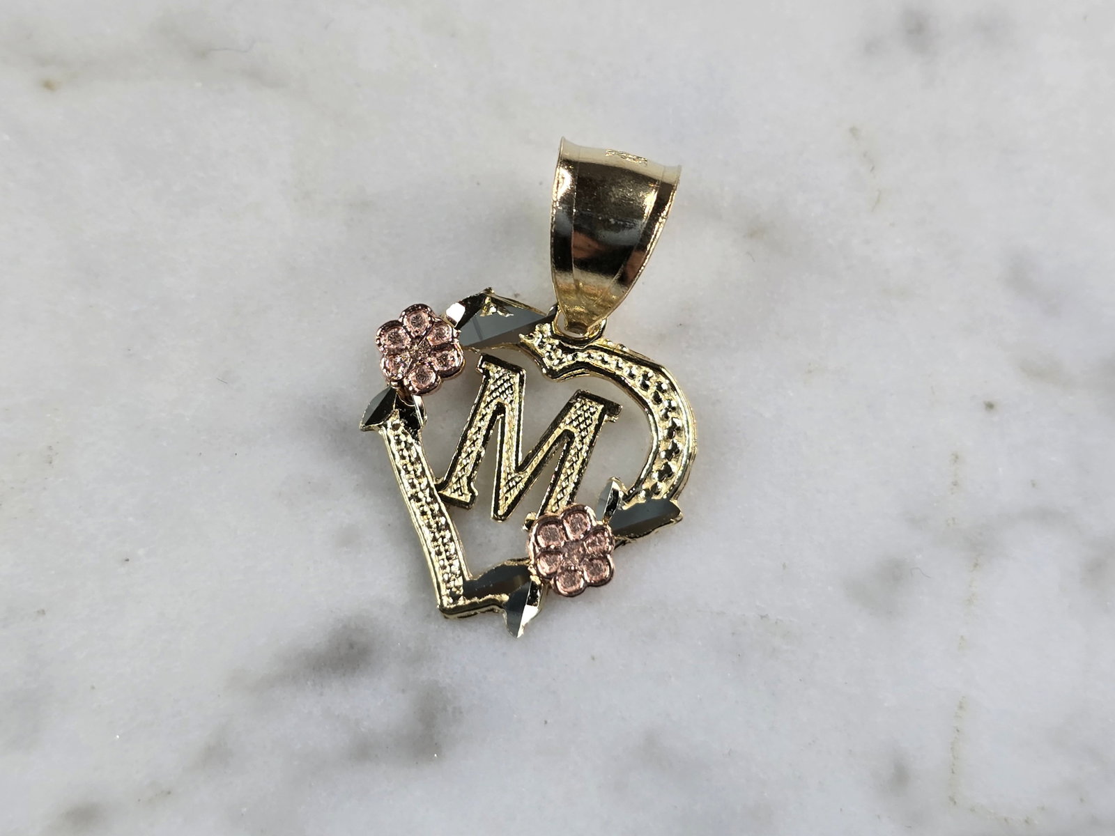 Womens 10K Yellow & Rose Gold Initial Letter " M " Heart Pendant: A WOMENS 10K YELLOW & ROSE GOLD "M" HEART PENDANT. PENDANT MEASURES 3/4" LONG BY 5/8" WIDE. TOTAL WEIGHT OF THE PENDANT IS 0.9g. WOULD MAKE A LOVELY GIFT FOR THAT SOMEONE SPECIAL. ANY QUESTIONS PLEASE