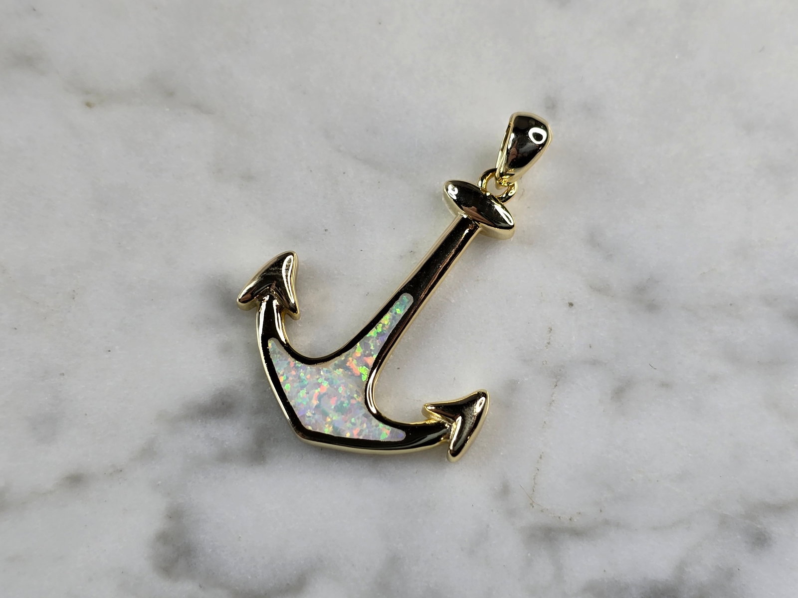Womens Sterling Silver Gold Tone Opal Anchor Pendant: A WOMENS STERLING SILVER GOLD TONE OPAL ANCHOR PENDANT. NOT SURE IF STONES ARE NATURAL OR MAN MADE. THE PENDANT WEIGHS 3.0g AND MEASURES 1 1/4" LONG BY 3/4" WIDE. MAKES A GREAT GIFT FOR THAT SOMEONE S