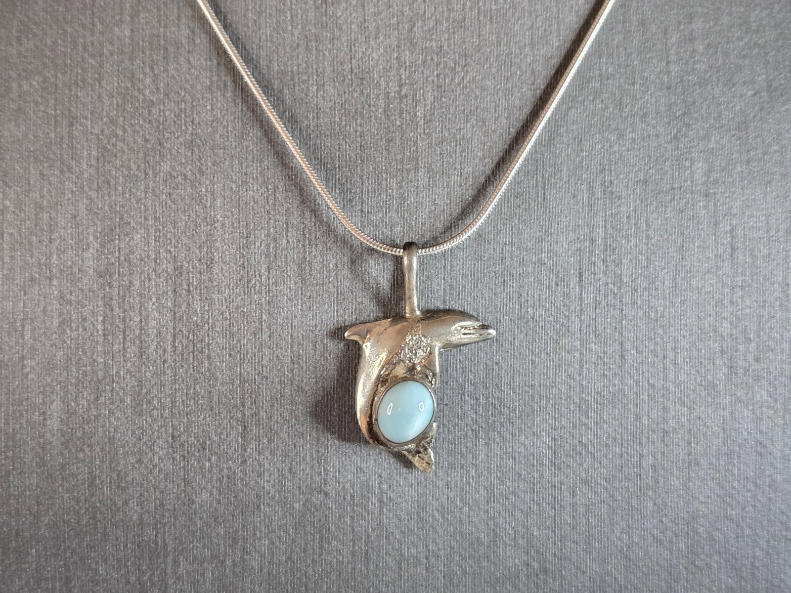 Womens Vintage Estate Sterling Silver Larimar Dolphin Pendant Necklace: A WOMENS VINTAGE ESTATE STERLING SILVER LARIMAR STONE DOLPHIN PENDANT WITH NECKLACE. NOT SURE IF STONE IS REAL OR MAN MADE. THE PENDANT AND NECKLACE WEIGHS 6.3g. THE NECKLACE MEASURES 16" LONG, AND TH