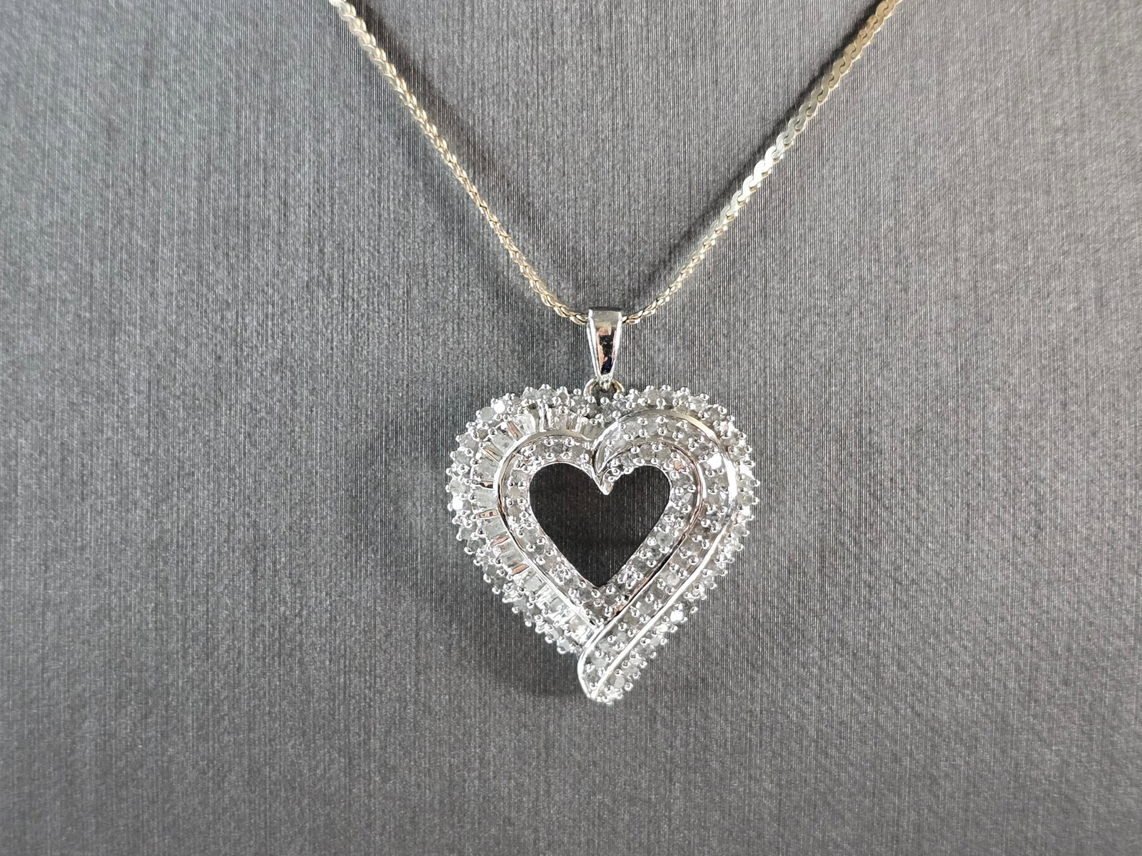 Womens Vintage Estate Sterling Silver Diamond Heart Pendant Necklace: A WOMEN'S VINTAGE ESTATE STERLING SILVER DIAMOND HEART PENDANT WITH NECKLACE. THE TOTAL WEIGHT IS 10.3g. THE NECKLACE MEASURES 24" LONG. THE PENDANT MEASURES 1 1/4" BY 1". THERE ARE ABOUT 95 TINY DIAM
