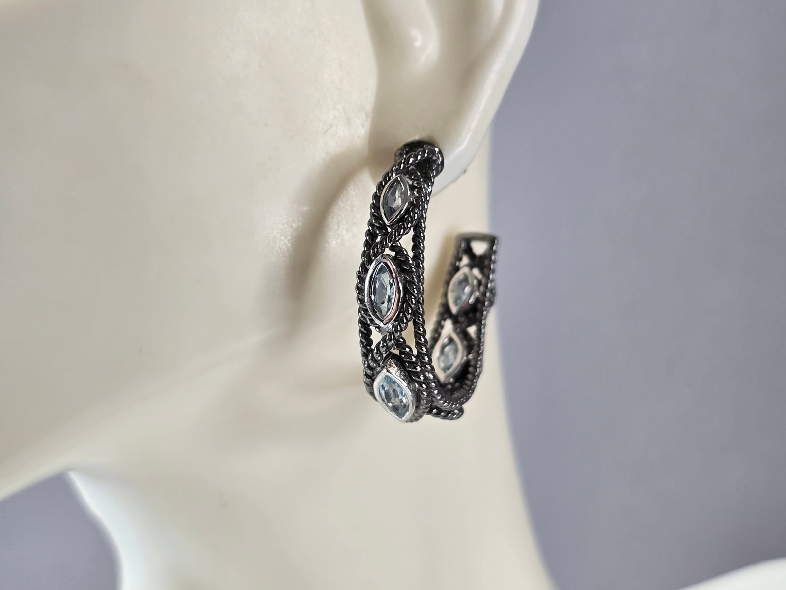 Womens Vintage Estate Sterling Silver Modernist Topaz Hoop Earrings: A PAIR OF WOMENS VINTAGE ESTATE STERLING SILVER MODERNIST TOPAZ COLORED HOOP EARRINGS THAT WEIGH 11.1g, AND MEASURE 1 1/8" LONG BY 1/4" WIDE. NOT SURE IF STONES ARE NATURAL OR MAN MADE. ANY QUESTIONS,