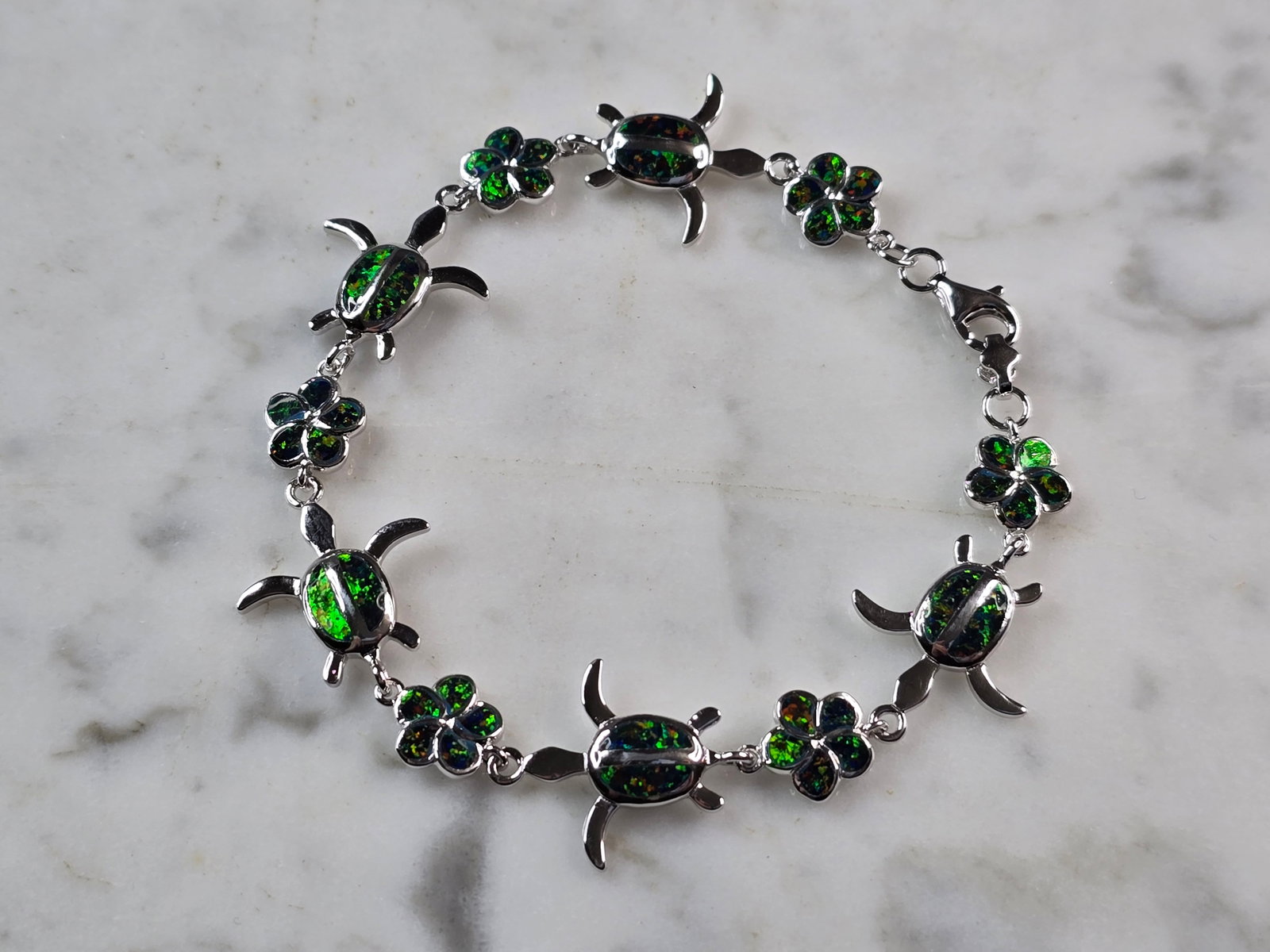 Womens Estate Sterling Silver Opal Sea Turtle Bracelet: A WOMENS ESTATE STERLING SILVER MODERNIST OPAL COLORED SEA TURTLE BRACELET. THE BRACELET WEIGHS 10.1g AND MEASURES 7" LONG BY 5/8" WIDE. NOT SURE IF OPAL IS NATURAL OR MAN MADE. ANY QUESTIONS PLEASE D