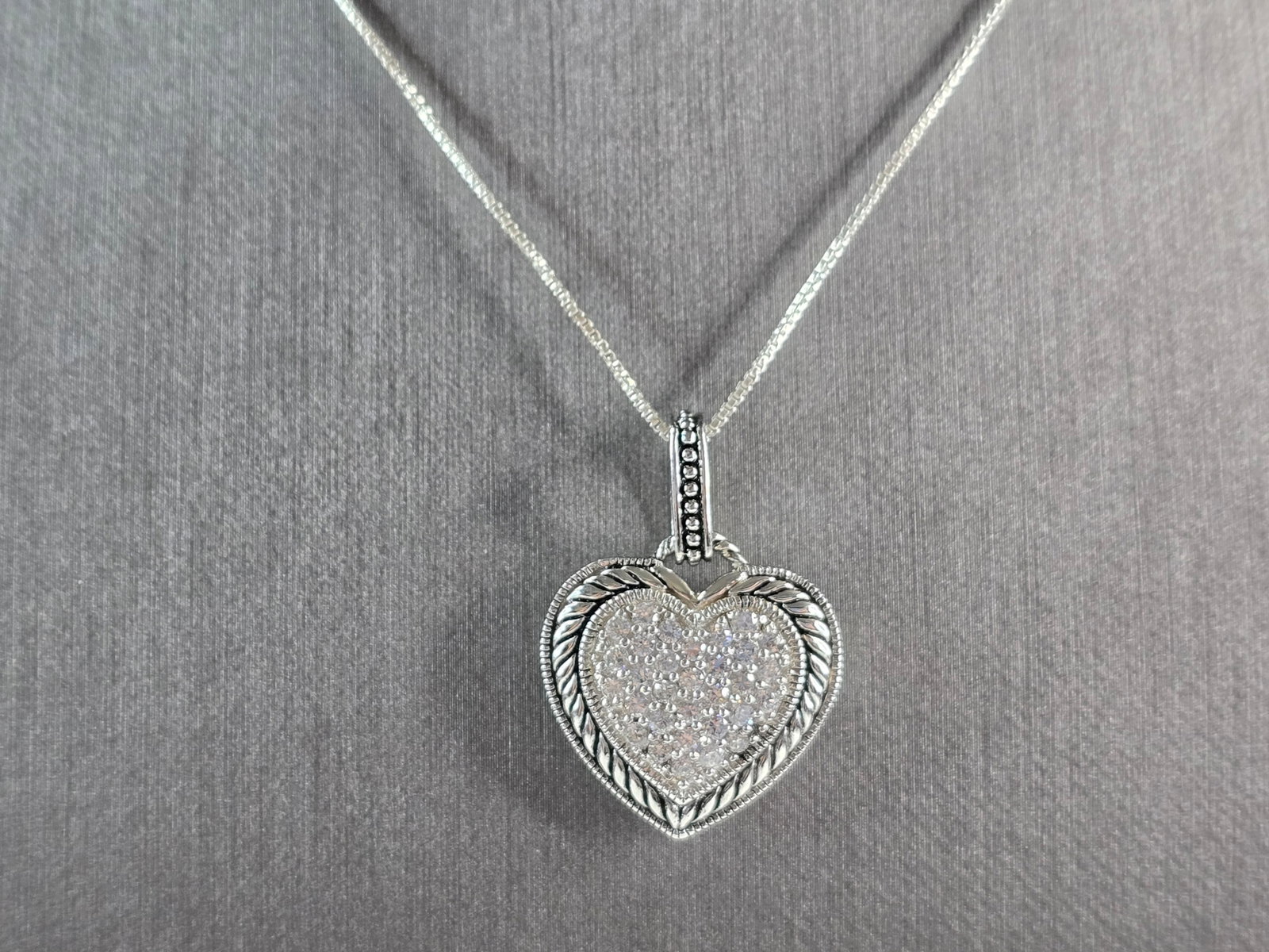Womens Estate Sterling Silver Heart CZ Stone Pendant W/ Necklace: A WOMENS ESTATE STERLING SILVER HEART CZ STONE PENDANT WITH NECKLACE. TOGETHER THEY WEIGH 8.3g. PENDANT MEASURES 1 1/8" LONG BY 7/8" WIDE. NECKLACE MEASURES 18". MAKES A GREAT GIFT FOR THAT SOMEONE SP