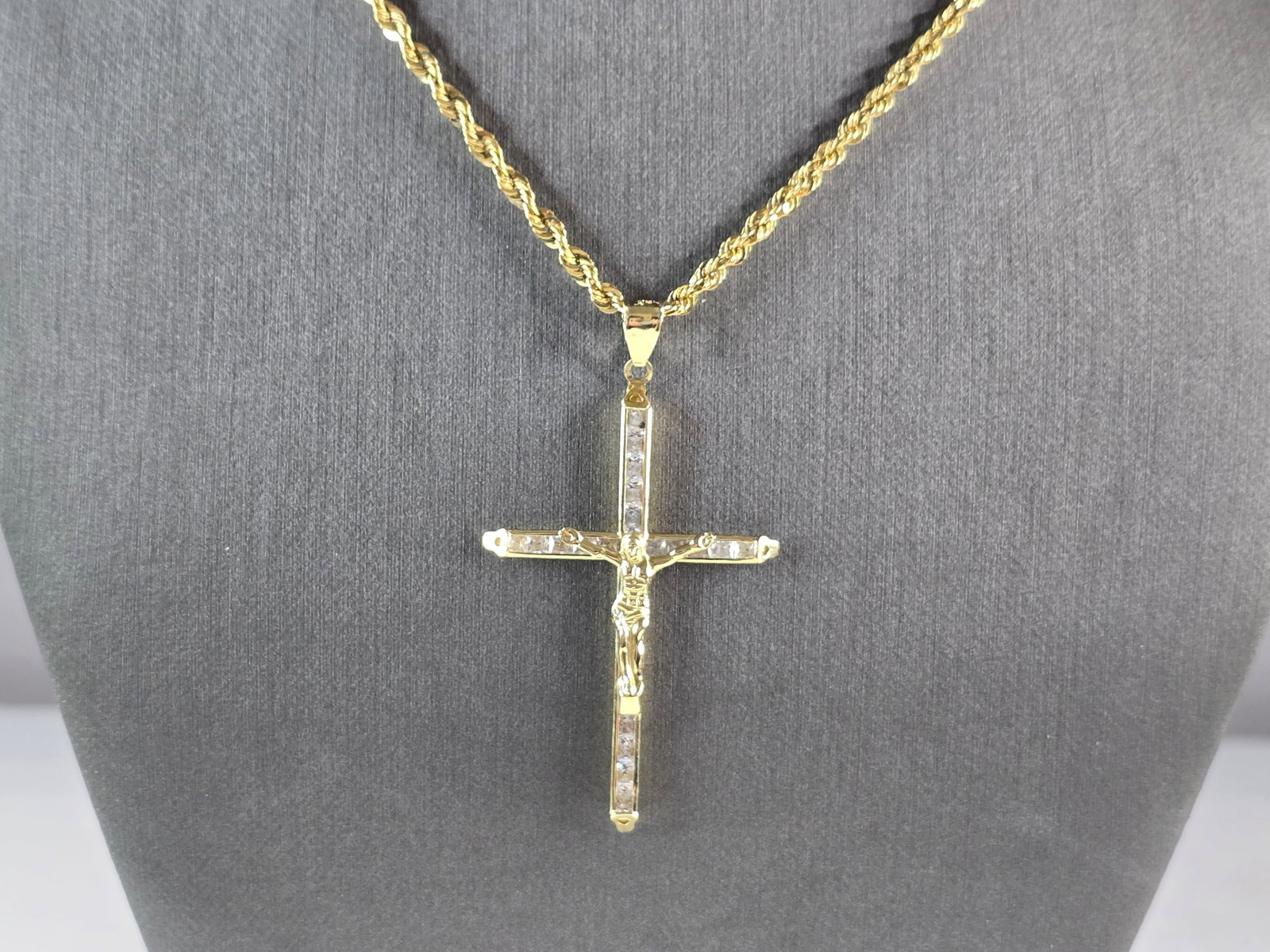 Vintage Estate 10k Gold Jesus Cross Pendant w/ Rope Necklace: A VINTAGE ESTATE 10K GOLD ROPE NECKLACE WITH A CZ JESUS CROSS PENDANT. TOGETHER THE CROSS AND NECKLACE WEIGHS 6.4g. THE PENDANT MEASURES 2 1/4" BY 1 1/4". THE NECKLACE MEASURES 26" LONG BY 1/8" WIDE. 