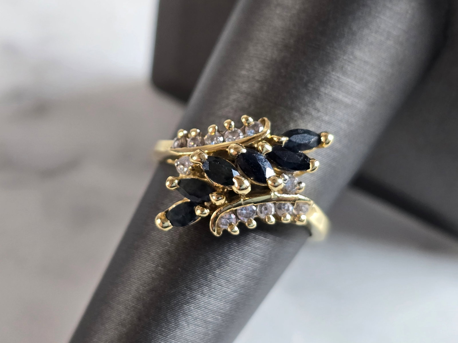 Womens Vintage Estate 14K Gold Diamond Sapphire Ring: A WOMENS VINTAGE ESTATE 14K GOLD DIAMOND SAPPHIRE RING. THE RING WEIGHS 4.6g, AND IS A SIZE IS 7.75. THERE ARE A TOTAL OF 12 SMALL DIAMONDS. THE LENGTH OF THE RING IS 5/8". ANY QUESTIONS, PLEASE DON'T