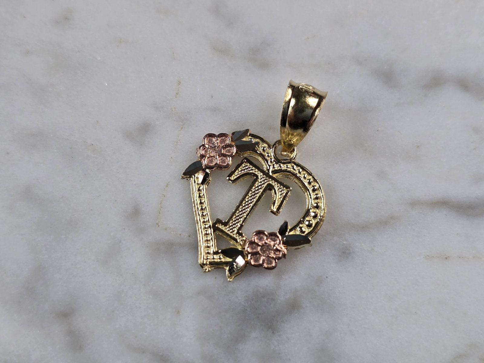 Womens 10K Yellow & Rose Gold Initial Letter " T " Heart Pendant: A WOMENS 10K YELLOW & ROSE GOLD "T" HEART PENDANT. PENDANT MEASURES 3/4" LONG BY 1/2" WIDE. TOTAL WEIGHT OF THE PENDANT IS 0.6g. WOULD MAKE A LOVELY GIFT FOR THAT SOMEONE SPECIAL. ANY QUESTIONS PLEASE