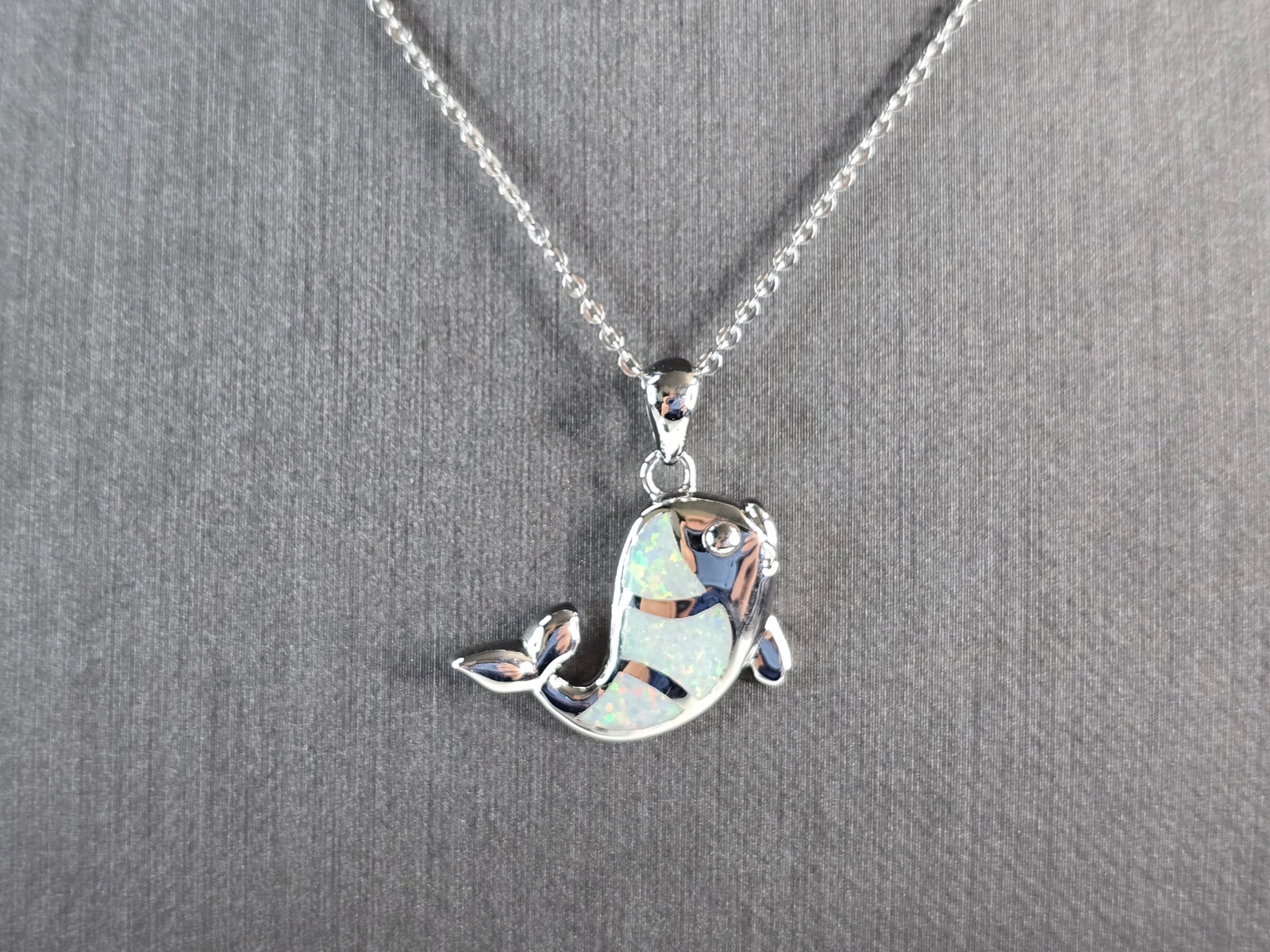 Womens Sterling Silver Opal Fish Pendant Necklace: A WOMENS STERLING SILVER OPAL FISH PENDANT WITH NECKLACE. THE PENDANT WITH NECKLACE WEIGHS 6.4g. THE PENDANT MEASURES 1" LONG BY 3/4" WIDE, AND THE NECKLACE MEASURES 18" LONG, ADJUSTABLE TO 16" LONG. 