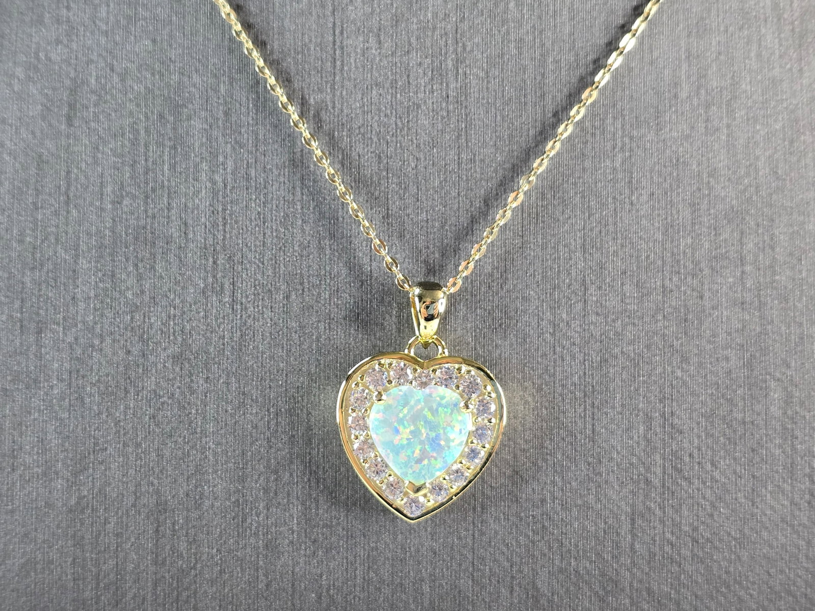 Womens Sterling Silver Gold Tone Opal Heart Pendant Necklace: A WOMENS STERLING SILVER GOLD TONE OPAL HEART PENDANT. THE PENDANT WITH NECKLACE WEIGHS 5.8g. THE PENDANT MEASURES 7/8" LONG BY 5/8" WIDE, AND THE NECKLACE MEASURES 18" LONG, ADJUSTABLE TO 16" LONG. N