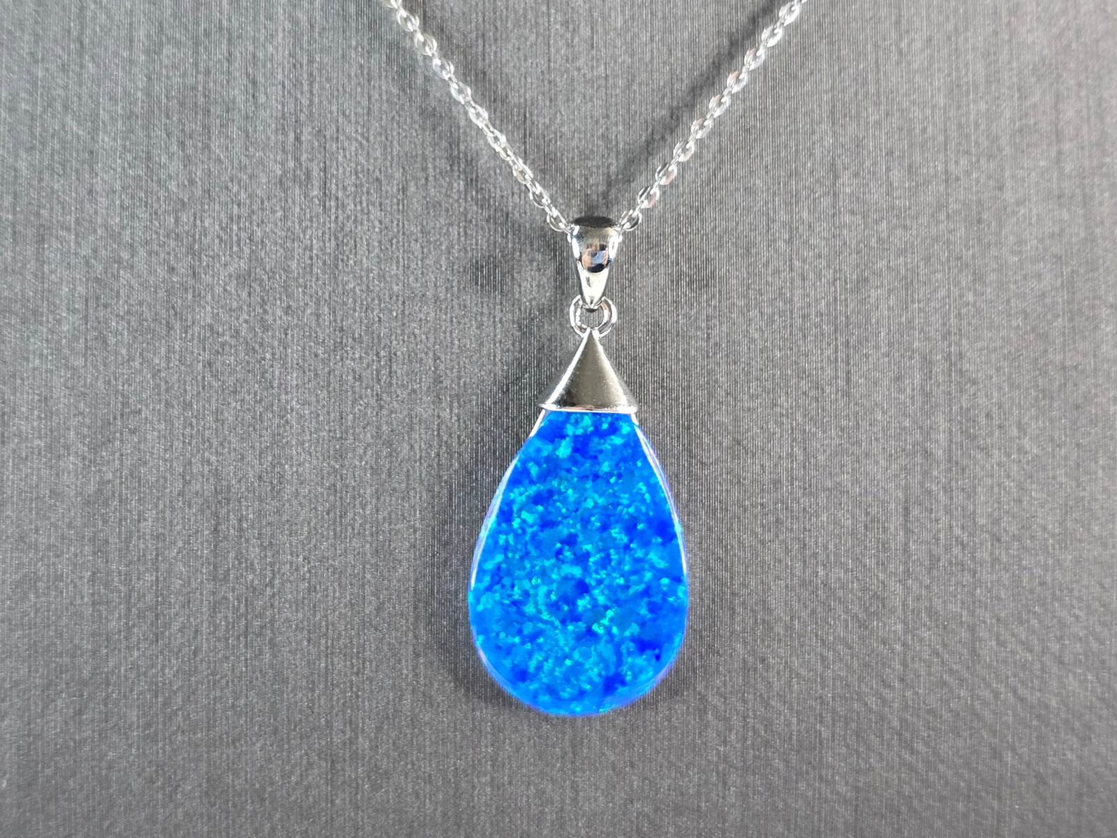 Womens Sterling Silver Blue Opal Modernist Pendant Necklace: A WOMENS STERLING SILVER BLUE OPAL MODERNIST PENDANT. THE PENDANT WITH NECKLACE WEIGHS 5.3g. THE PENDANT MEASURES 1 1/4" LONG BY 5/8" WIDE, AND THE NECKLACE MEASURES 18" LONG, ADJUSTABLE TO 16" LONG. 