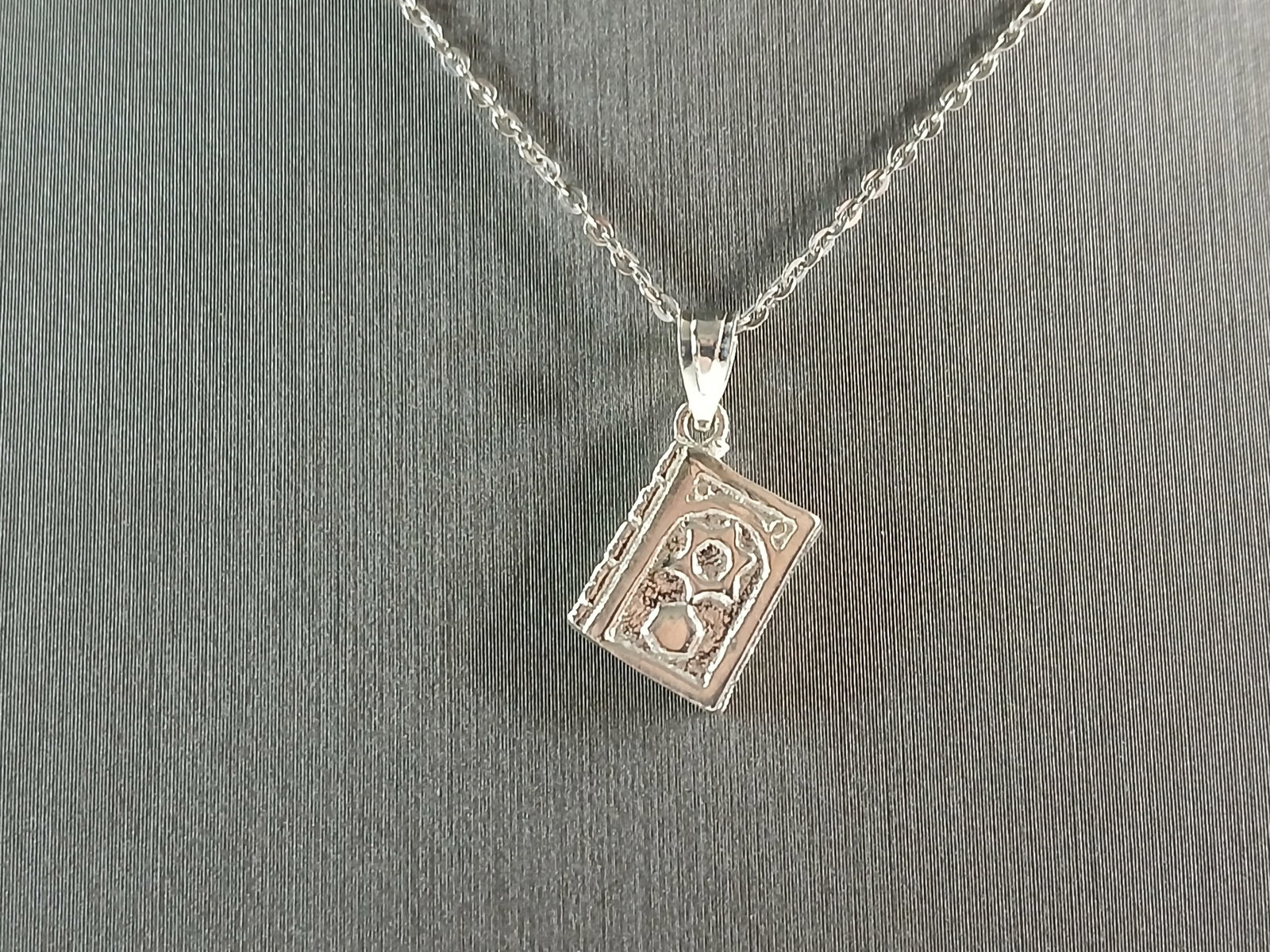 Sterling Silver Jewish Judaica Hebrew Torah Charm Pendant Necklace: A STERLING SILVER JEWISH HEBREW TORAH CHARM PENDANT. PENDANT WITH THE NECKLACE WEIGHS 3.6g. THE NECKLACE 18" LONG AND IS ADJUSTABLE TO 16" LONG. THE PENDANT MEASURES 3/4" LONG BY 3/8" WIDE. MAKES A GR