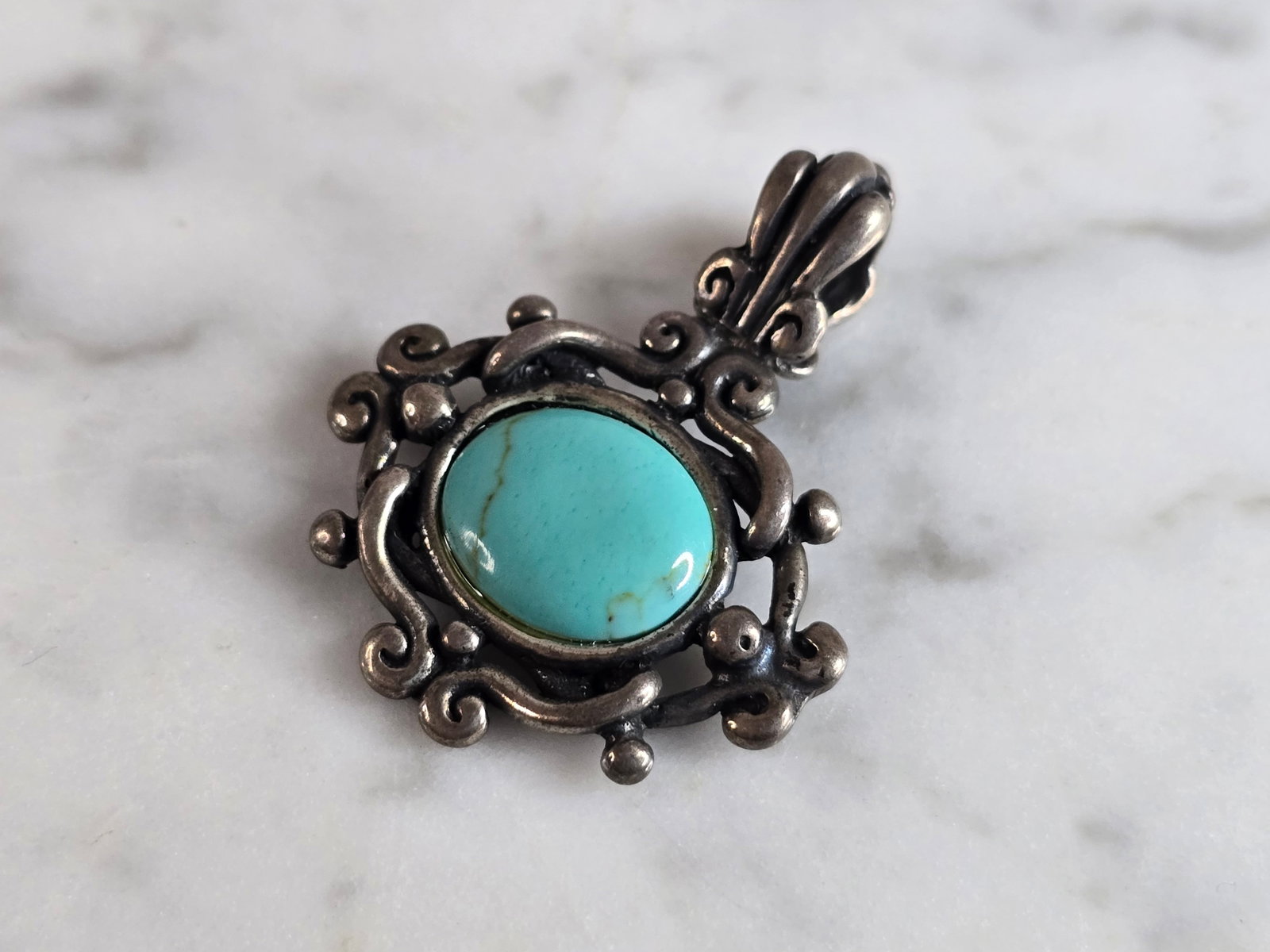 Womens Vintage Estate Sterling Silver Turquoise Pendant: A WOMENS VINTAGE ESTATE STERLING SILVER TURQUOISE PENDANT. NOT SURE IF STONE IS NATURAL OR MAN MADE. PENDANT WEIGHS 5.9g AND MEASURES 1 1/4" LONG BY 1" WIDE. MAKES A GREAT GIFT FOR THAT SOMEONE SPECIA