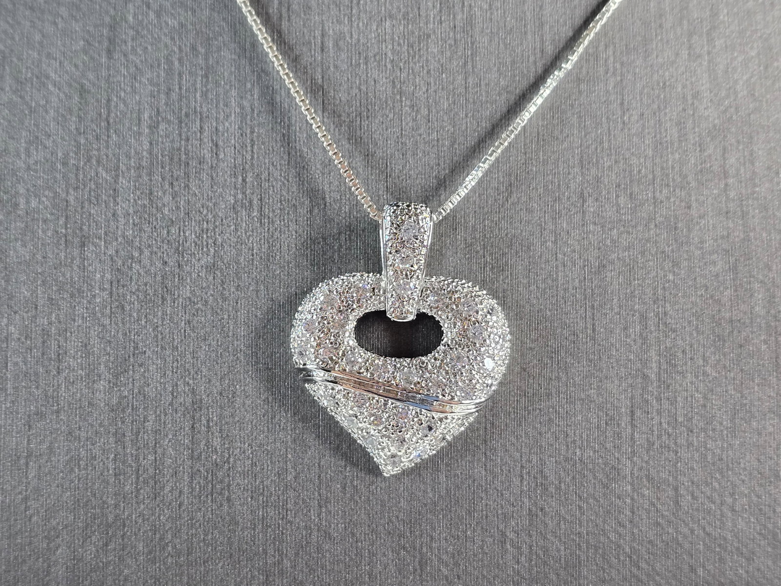 Womens Estate Sterling Silver Heart CZ Pendant W/ Necklace: A WOMENS ESTATE STERLING SILVER HEART CZ PENDANT WITH NECKLACE. TOGETHER THEY WEIGH 9.2g. PENDANT MEASURES 1 1/4" LONG BY 1" WIDE. NECKLACE MEASURES 18". MAKES A GREAT GIFT FOR THAT SOMEONE SPECIAL. I