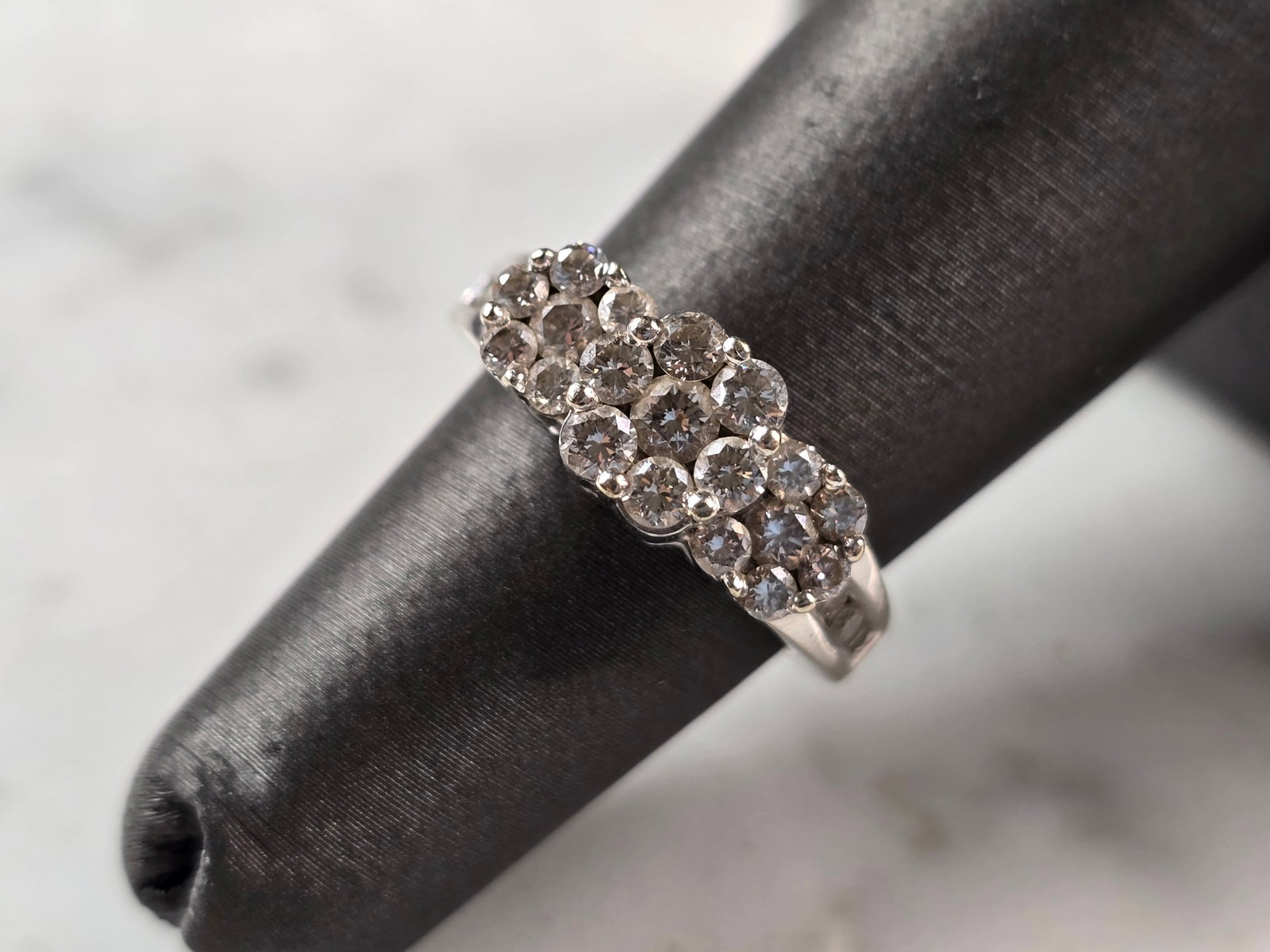 Womens Vintage Estate 10K White Gold Diamond Ring: A WOMENS VINTAGE ESTATE 10K WHITE GOLD DIAMOND RING. RING HAS A TOTAL OF ABOUT .75cts OF DIAMONDS. THE TOTAL WEIGHT IS 4.1g, AND IS A SIZE 5.0. THE WIDTH OF THE RING IS 1/4". RING IS MARKED 10k ON THE