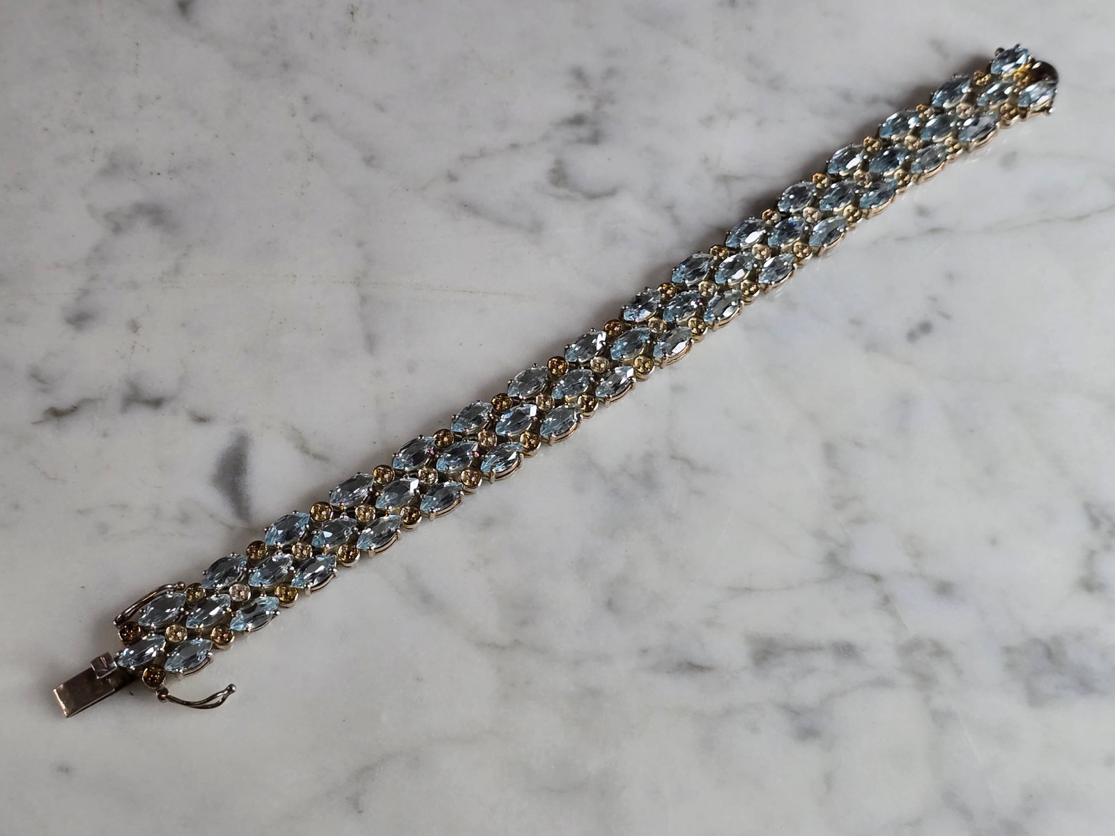 Womens Vintage Estate Sterling Silver Topaz Bracelet: A WOMENS VINTAGE WSTATE STERLING SILVER GOLD TONED TOPAZ COLORED BRACELET. NOT SURE IF STONES ARE NATURAL OR MAN MADE. BRACELET MEASURES 7 1/4" LONG BY 1/2" WIDE, AND WEIGHS 38.9g. WOULD MAKE A LOVELY