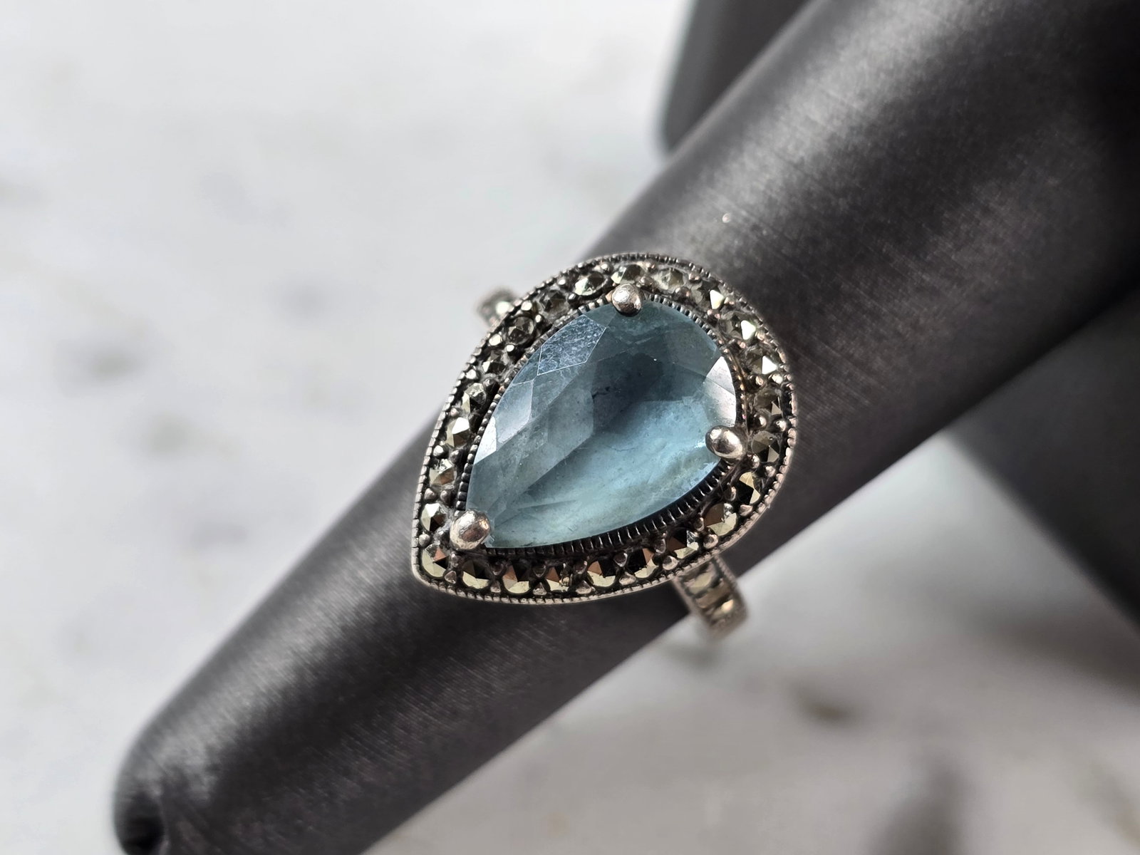Womens Vintage Estate Sterling Silver Topaz Ring: A WOMENS VINTAGE ESTATE STERLING SILVER TOPAZ COLORED RING. NOT SURE IF THE STONE IS NATURAL OR NOT. THE RING WEIGHS 8.5g, AND MEASURES 3/4" LONG. THE SIZE OF THE RING IS A 6.75. RING IS MISSING ONE T
