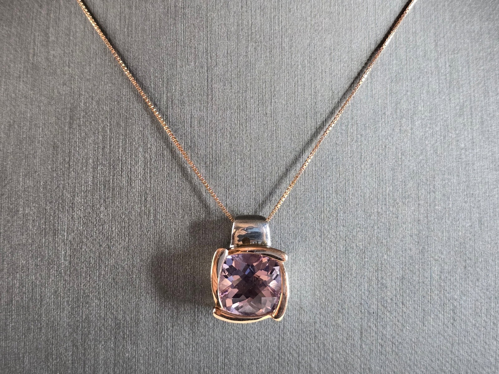 Womens Sterling Silver 14K Gold Amethyst Pendant W/ Necklace: A WOMENS VINTAGE ESTATE STERLING SILVER AND 14K GOLD AMETHYST COLORED STONE PENDANT WITH NECKLACE. NOT SURE IF STONE IS NATURAL OR MAN MADE. TOGETHER NECKLACE AND PENDANT WEIGHS 8.4g. PENDANT MEASURES