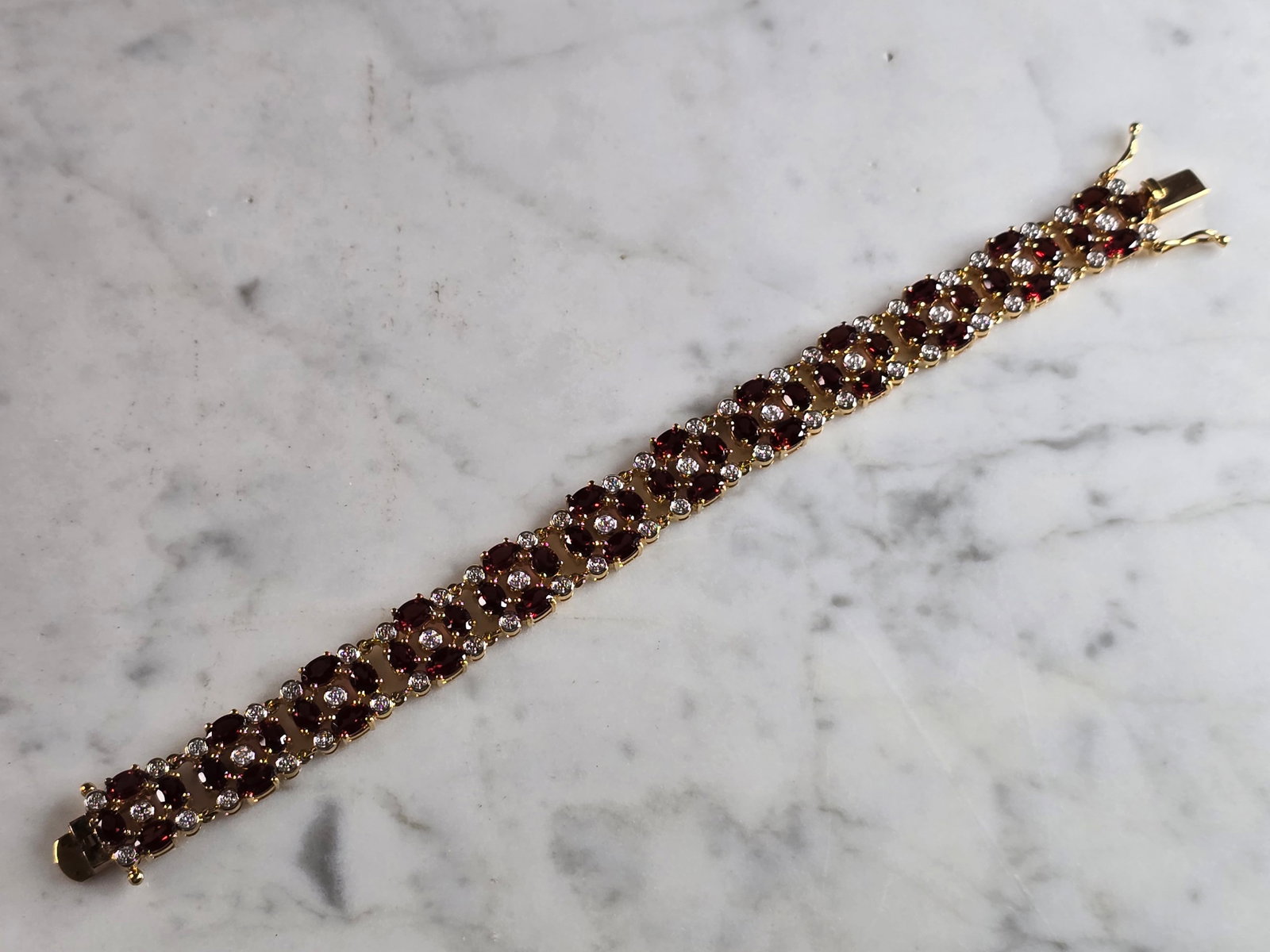 Womens Vintage Estate Sterling Silver Gold Tone Bracelet: A WOMENS VINTAGE WSTATE STERLING SILVER GOLD TONED RUBY COLORED BRACELET. BRACELET MEASURES 7 1/4" LONG AND 1/2" WIDE AND WEIGHS 27.8g. NOT SURE IF STONES ARE NATURAL OR MAN MADE. WOULD MAKE A LOVELY 