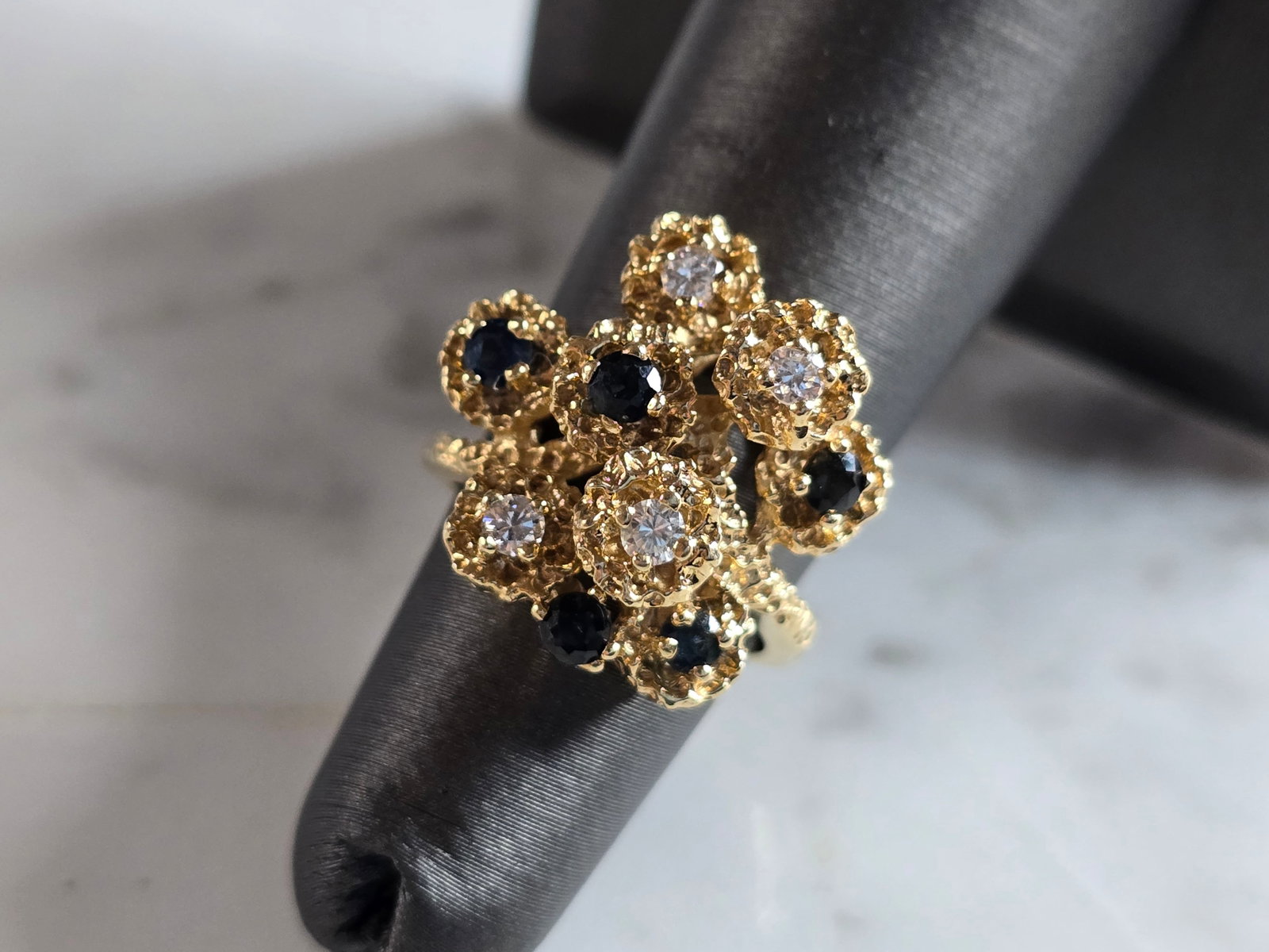 Womens Vintage Estate 14K Gold Sapphire & Diamond Ring: A WOMENS VINTAGE ESTATE 14K GOLD SAPPHIRE & DIAMOND RING. THE RING IS A SIZE 4.75 AND WEIGHS 6.6g. THERE ARE ABOUT .28cts OF DIAMONDS. THE WIDTH OF THE RING IS ABOUT 3/4". THE RING MAKES A BEAUTIFUL, 